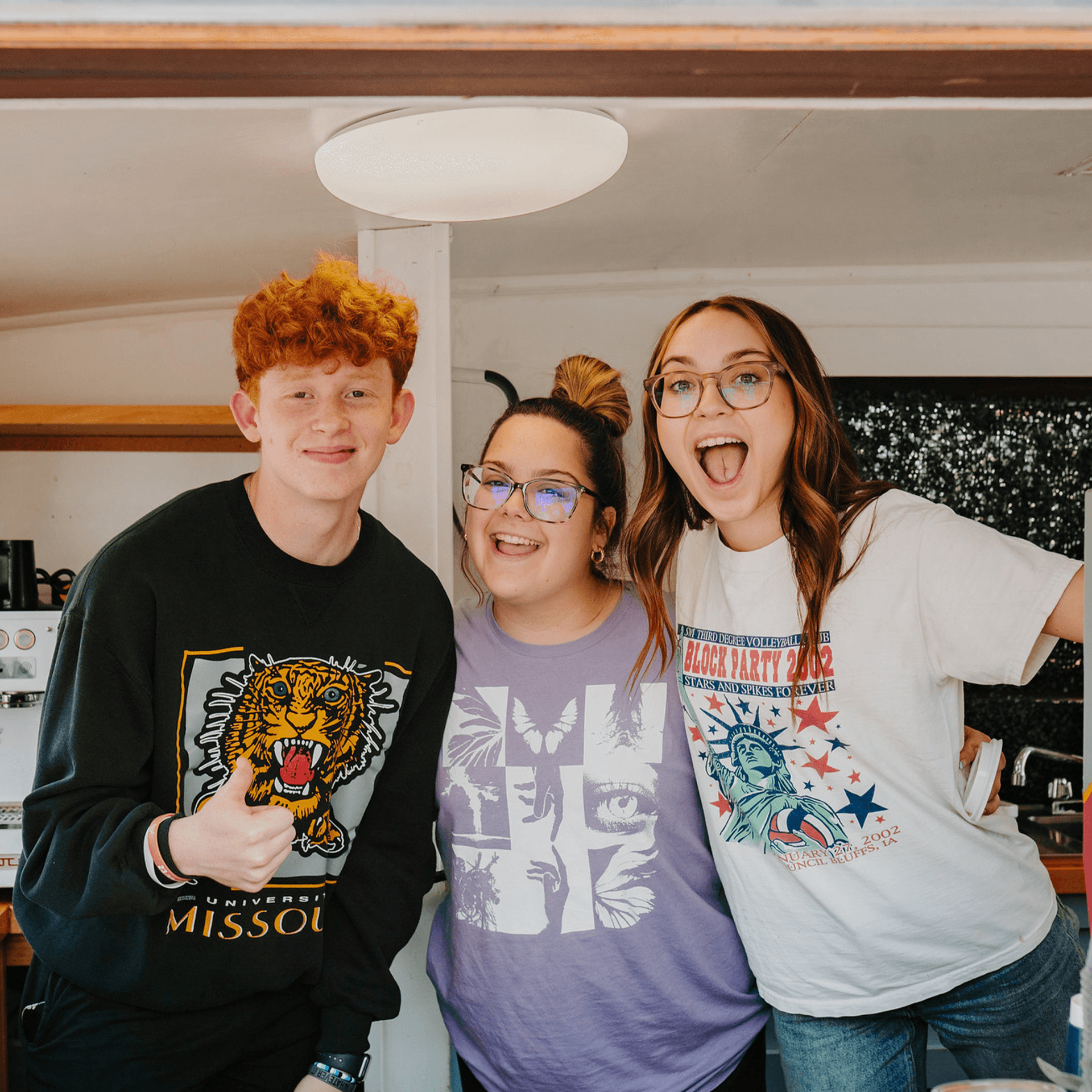 Three team members serving coffee.