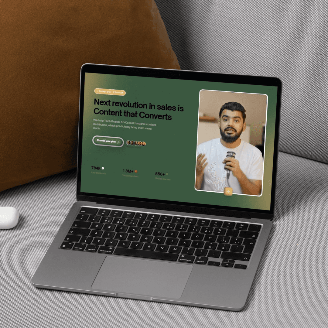 Red trolley car driving down a tree-lined street.