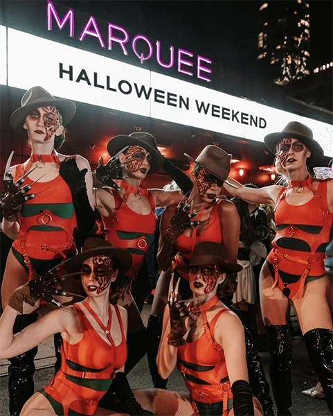 Horror-themed dancers in red at Marquee New York's Halloween weekend