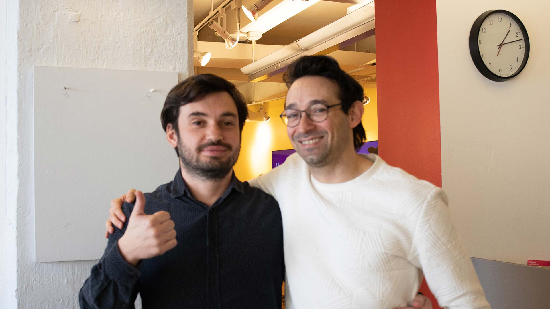 photo of two man with thumbs up