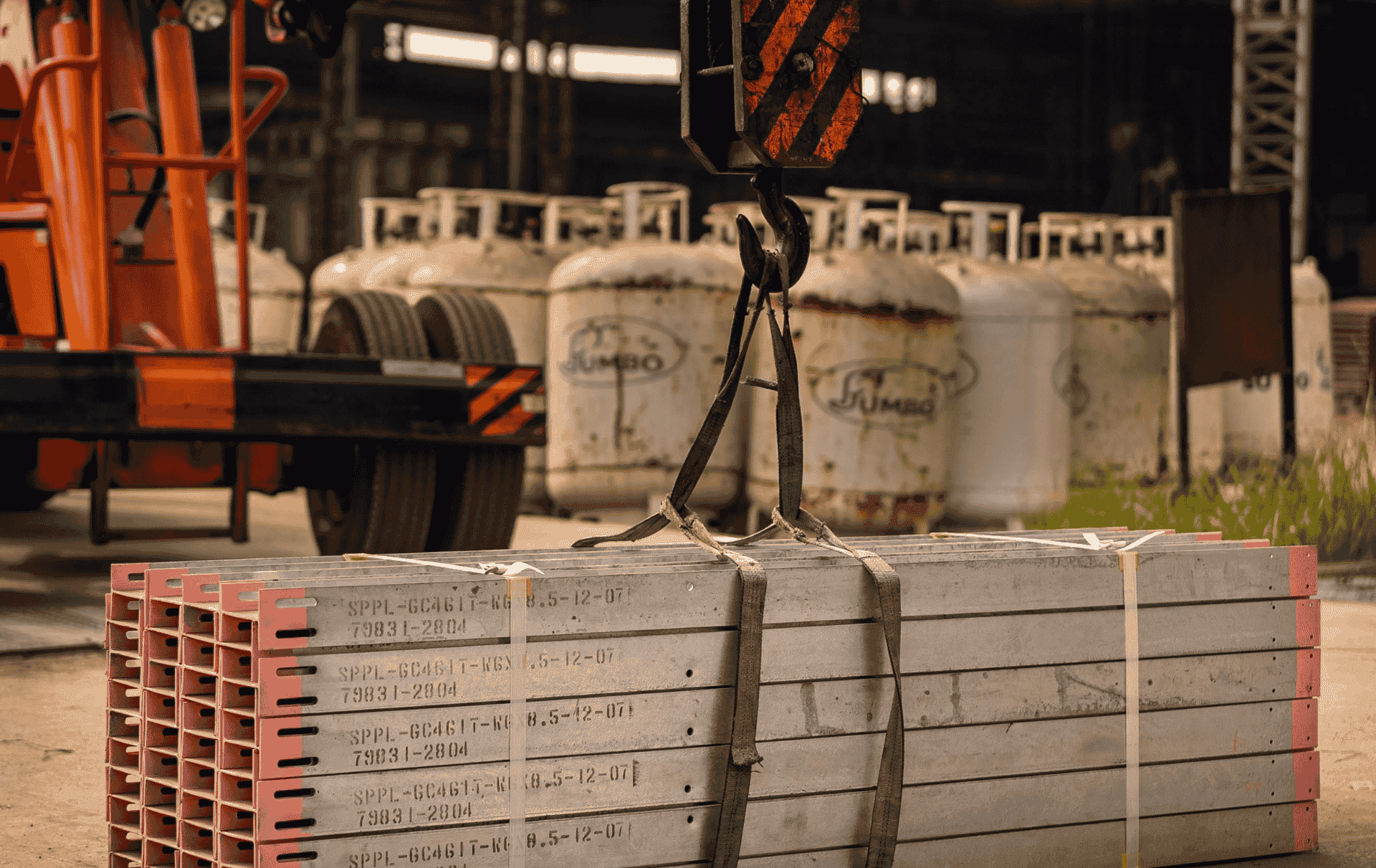 Large yellow mobile crane set up for a heavy lift rigging operation at an industrial site.