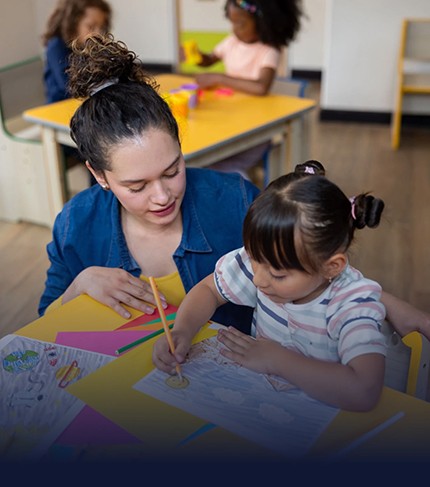 Cuidadora acompañando a una niña en actividad escolar