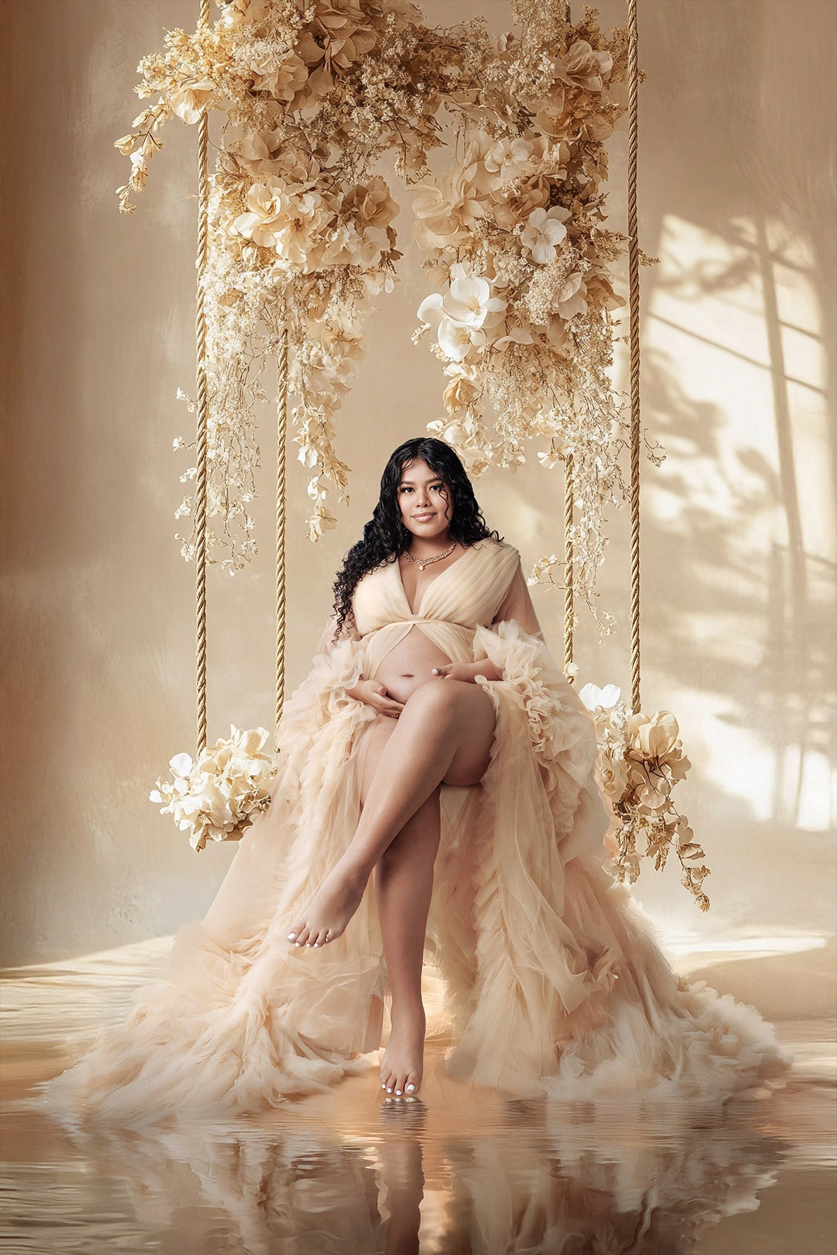 Elegant pregnancy portrait in Los Angeles studio — natural light and soft fabric.