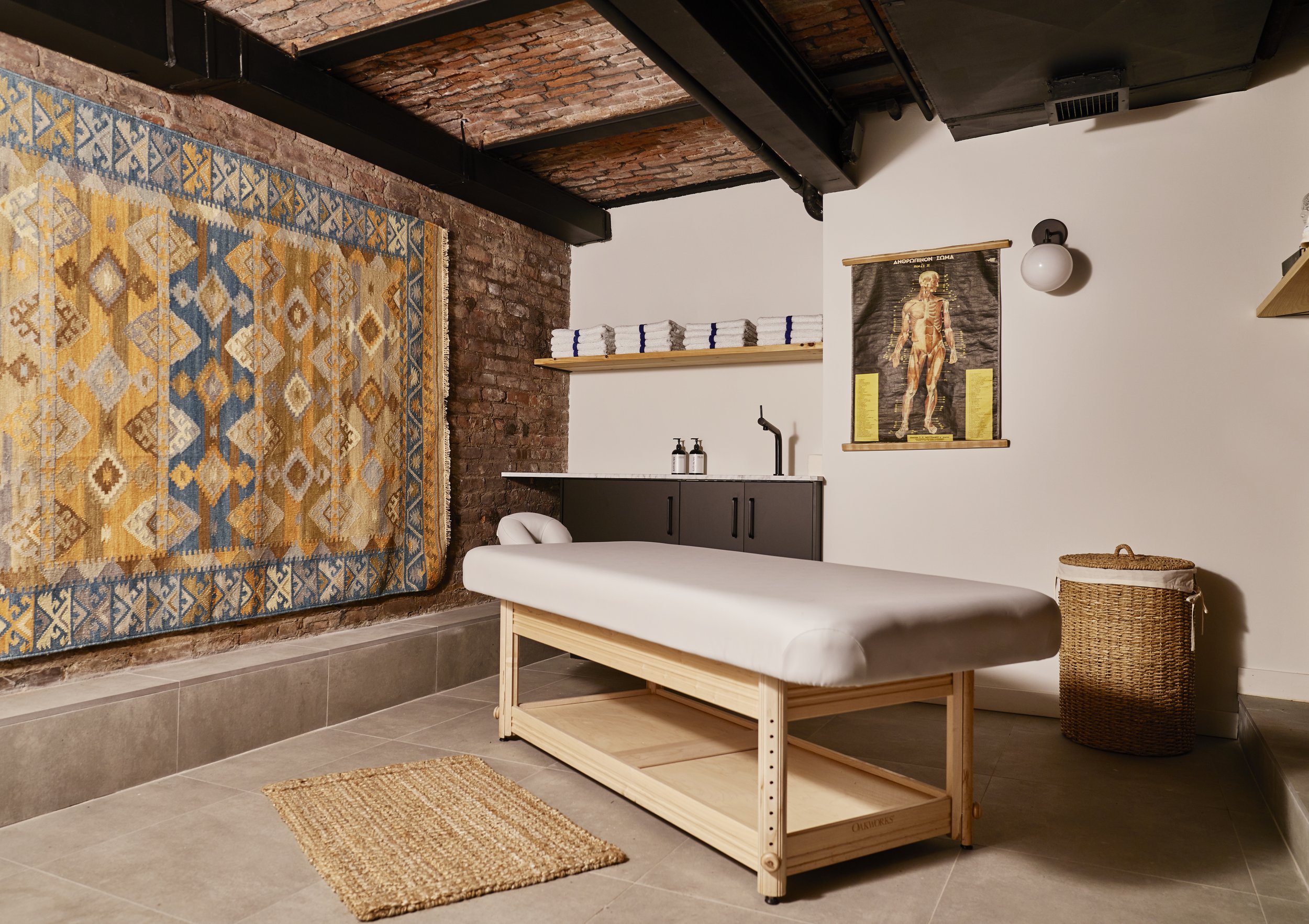 Image of a peaceful spa room with soft lighting and massage tables, inviting relaxation and rejuvenation.