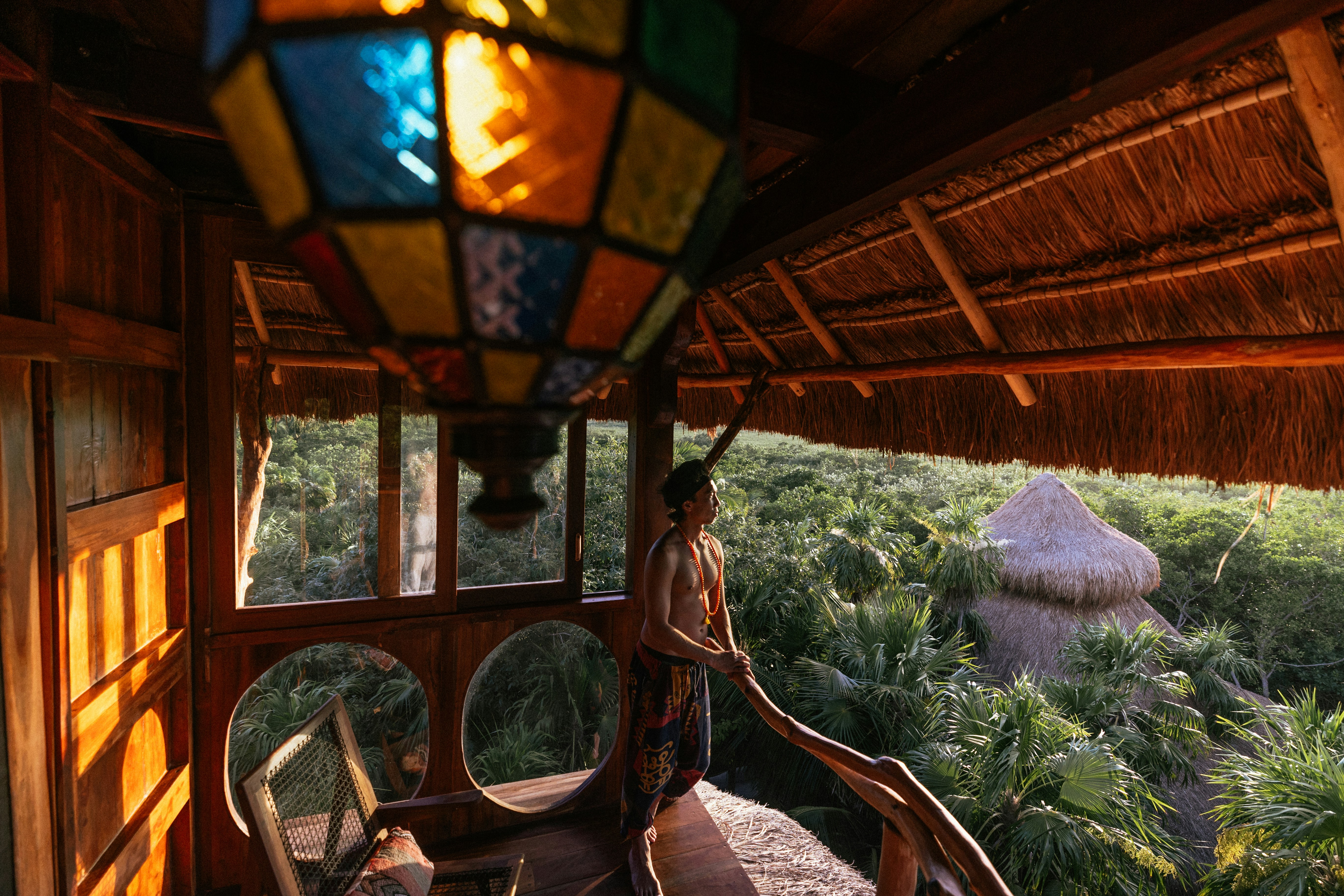 a woman standing on a porch next to a window