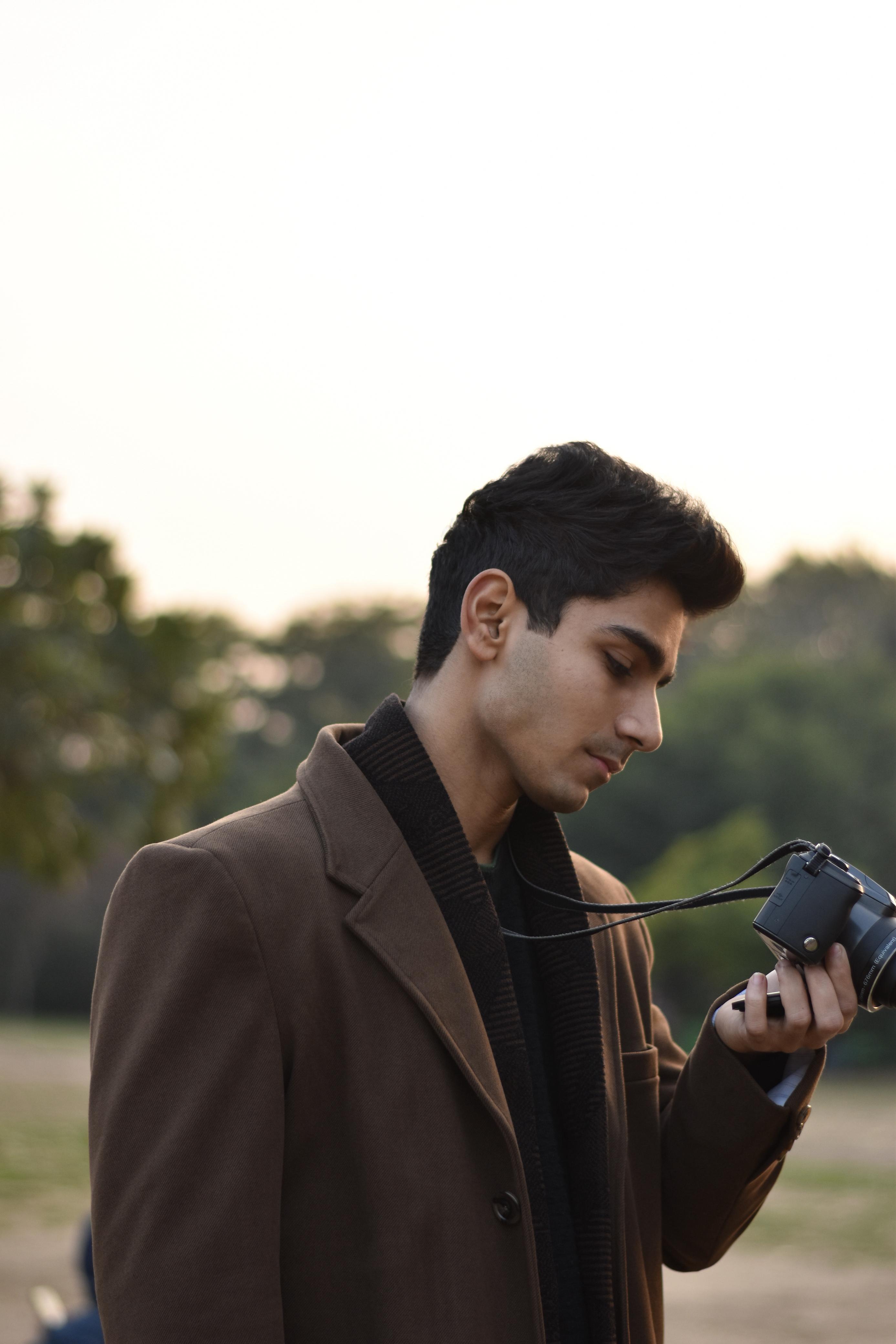 man in gray pullover hoodie sitting on black seat
