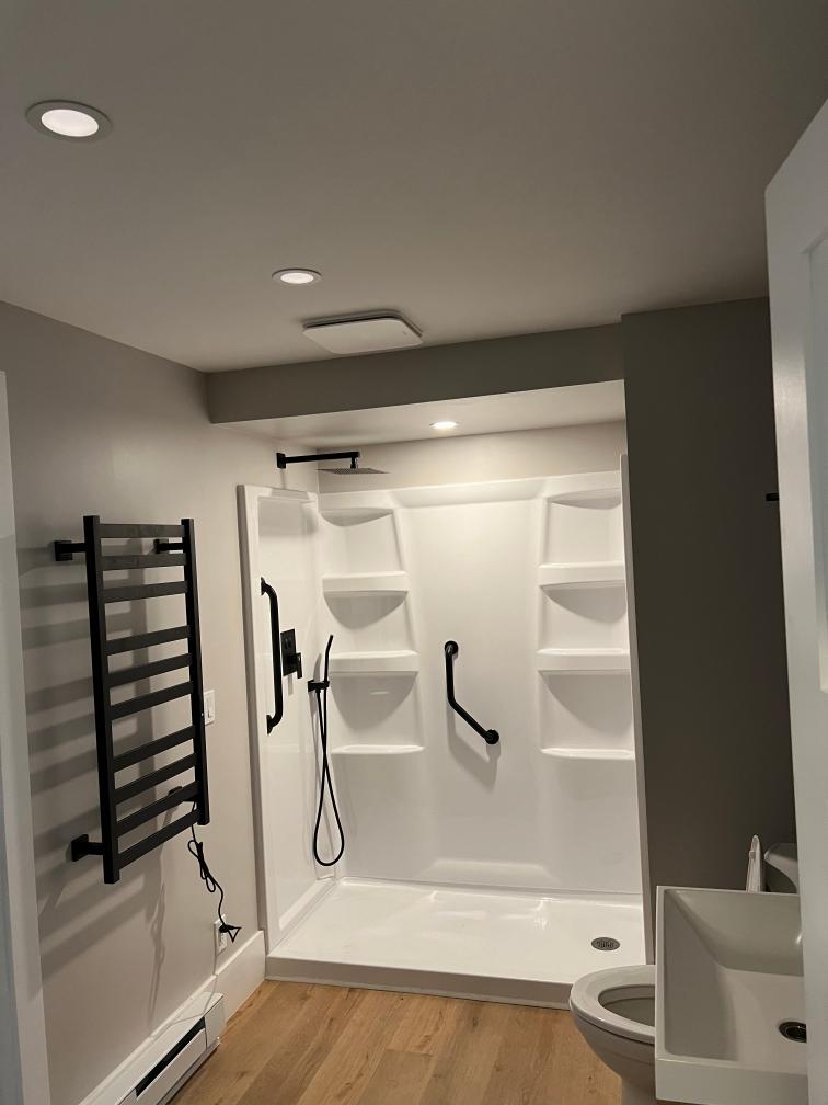 New bathroom addition with heated towel bars and walk in shower in the basement of a Dexter home.