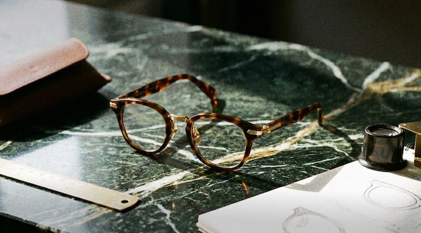 Detailed shot of a gold Tiffany & Co. necklace featuring a large geometric diamond-shaped pendant and a branded toggle clasp.