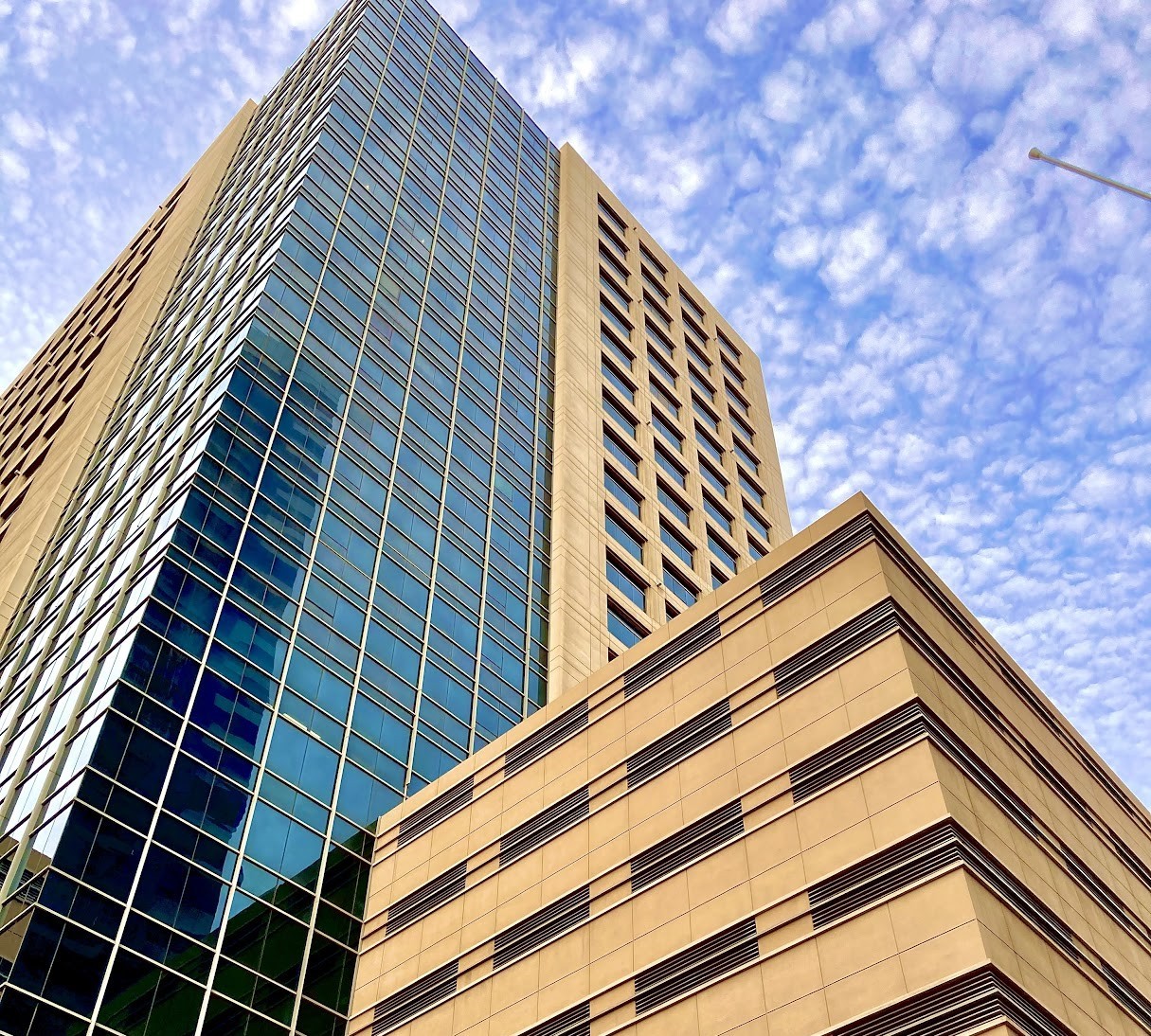 Low-angle shot of Grosvenor Business Tower signage against the sky, emphasizing modern commercial architecture.