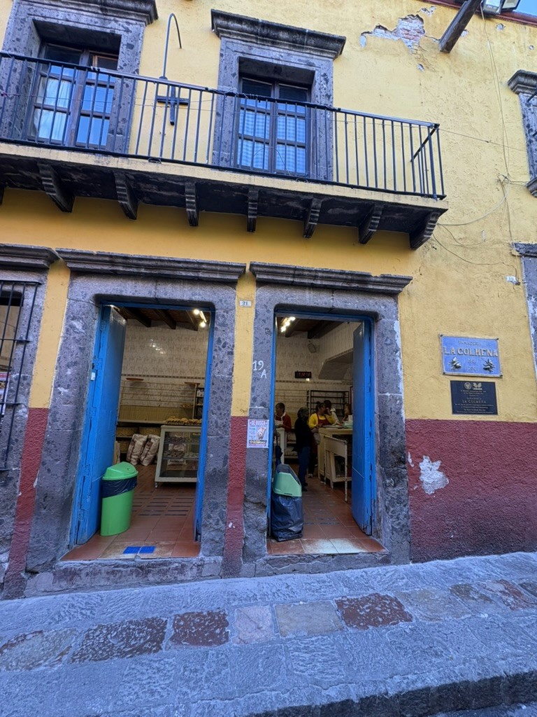 Blue and yellow La Colmena bakery storefront