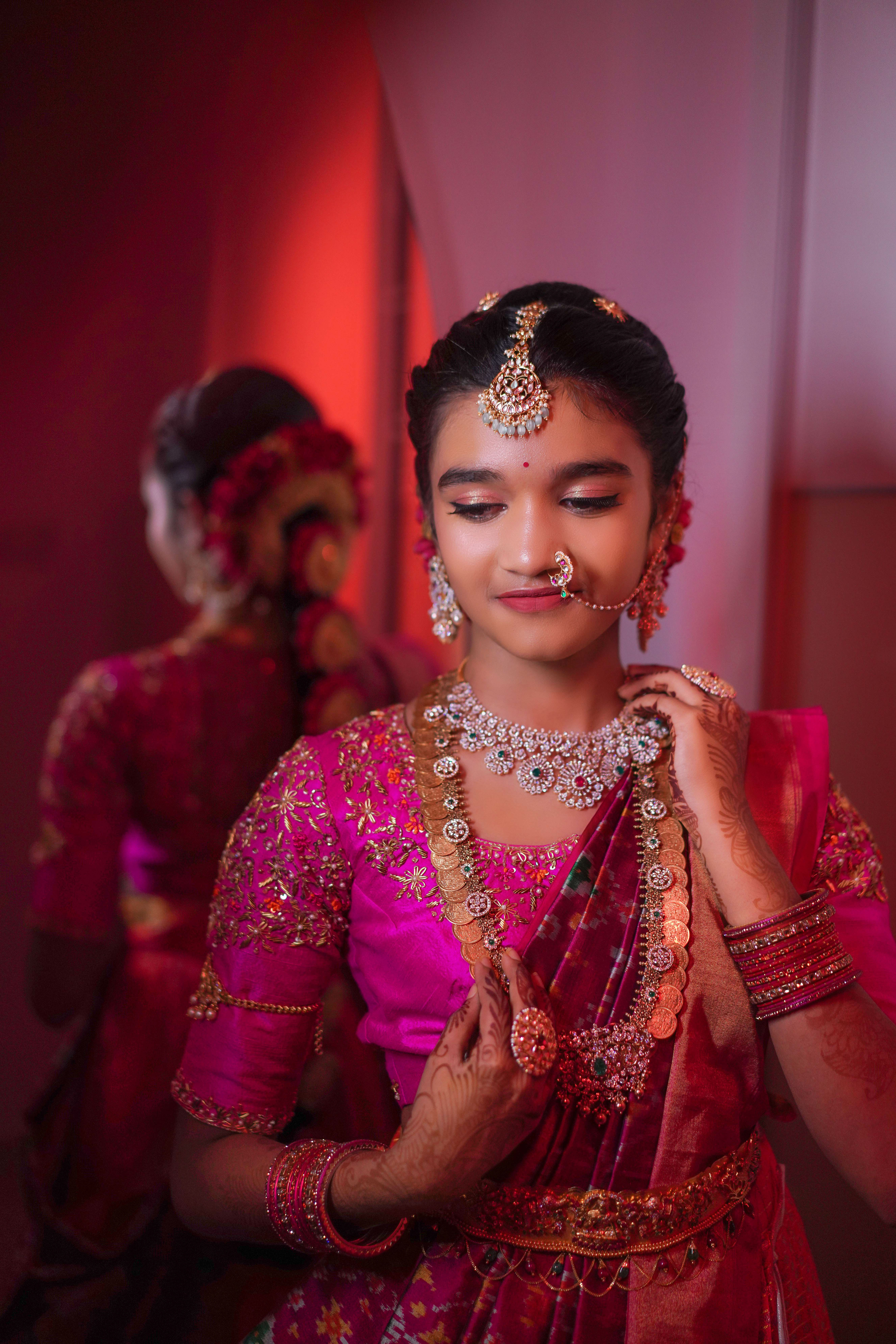 Silhouette of a person standing among tall redwood trees.