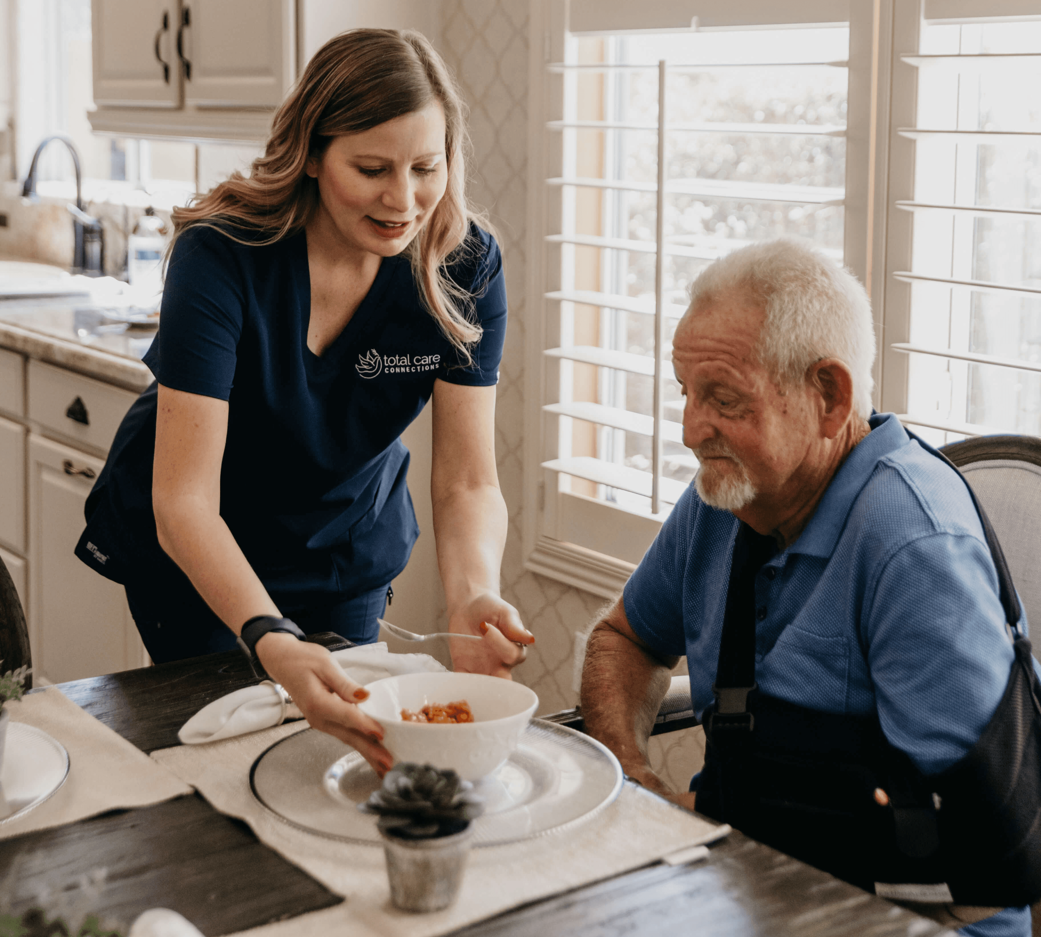 Total Care Connections caregiving serving lunch to client.