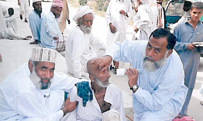 group of women in red and white dress standing on brown wooden bar during daytime