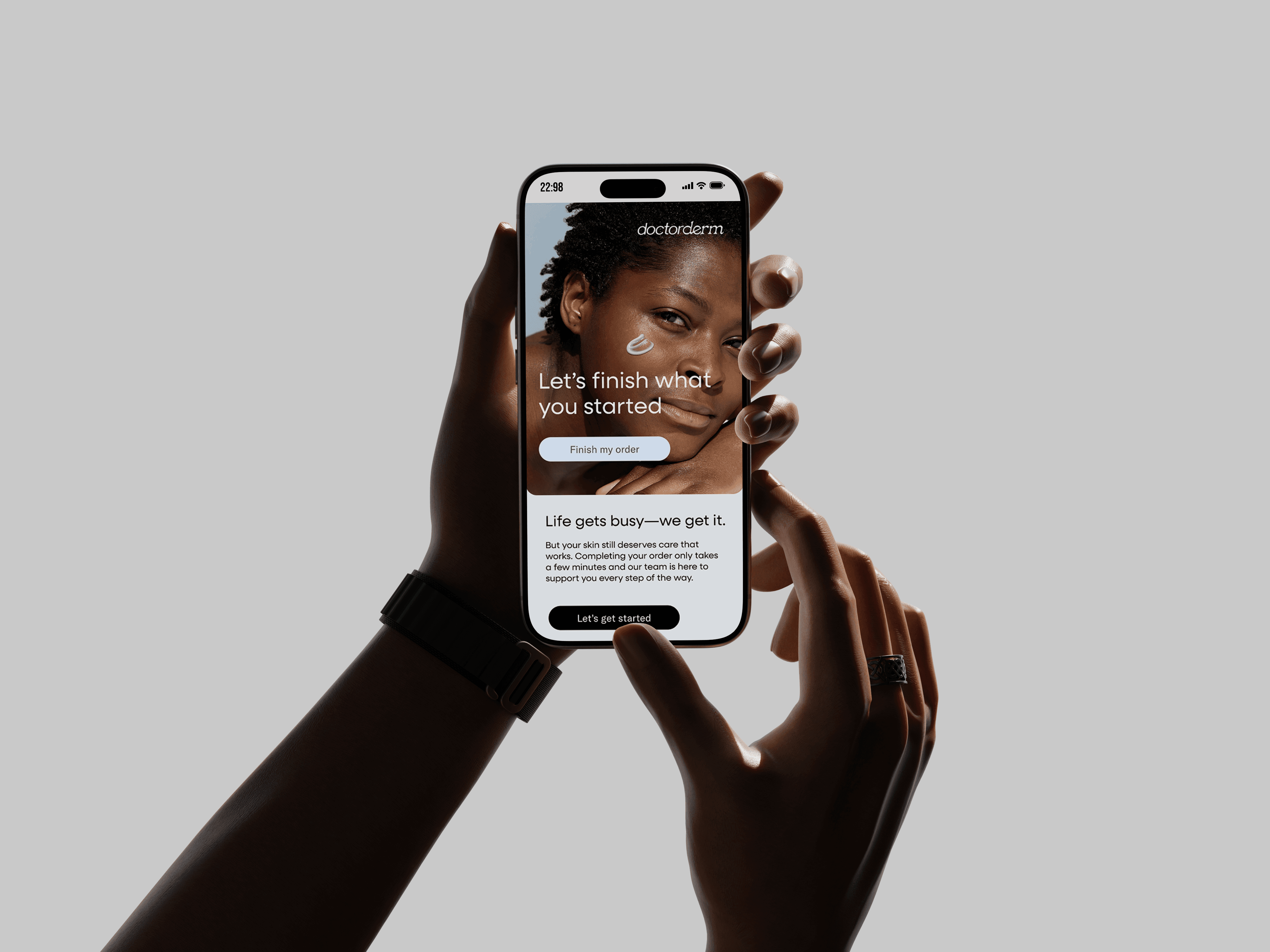 Hands holding a smartphone showing the Doctorderm skincare email.