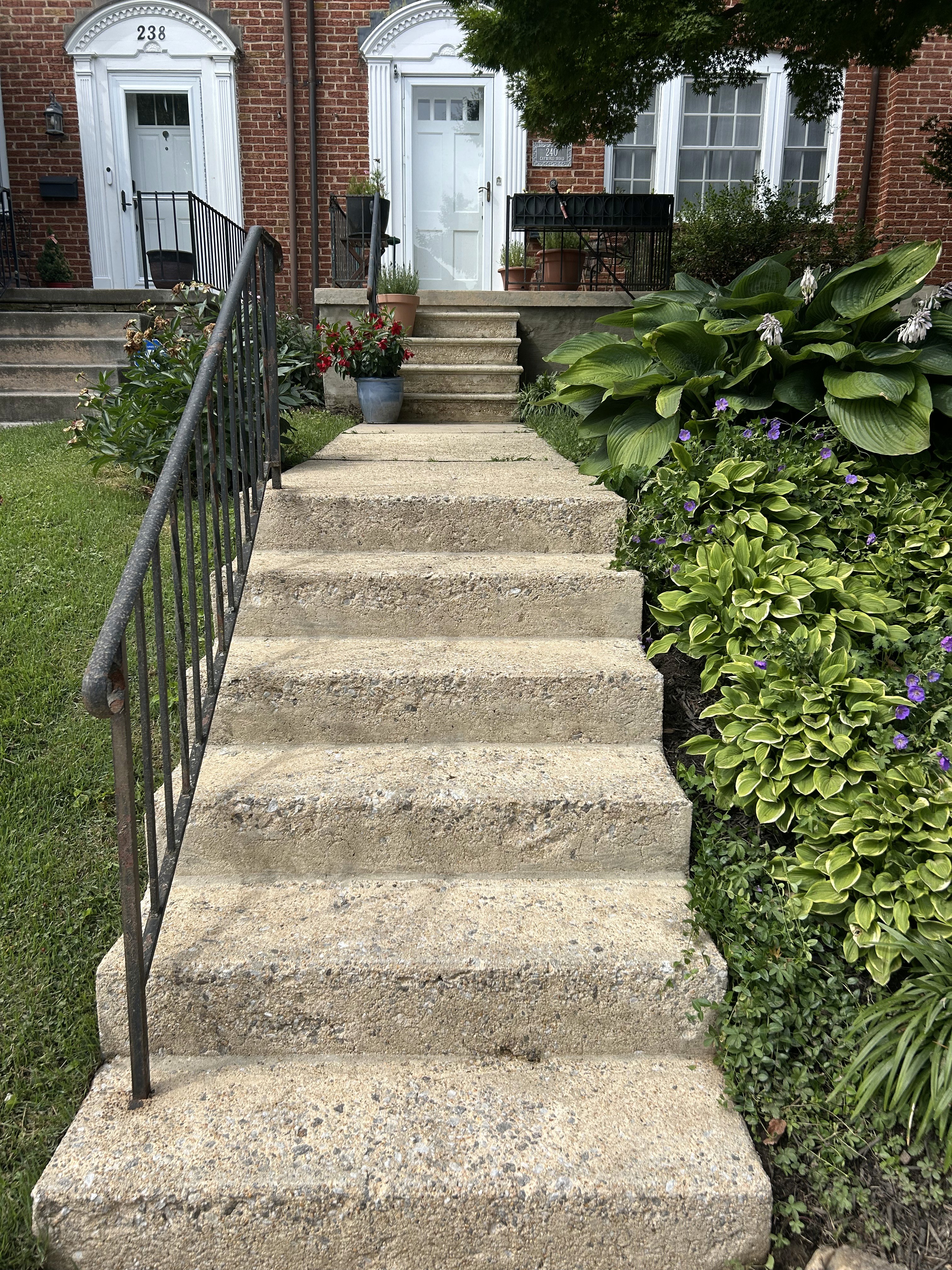 The same concrete front steps after professional pressure washing in Rodgers
