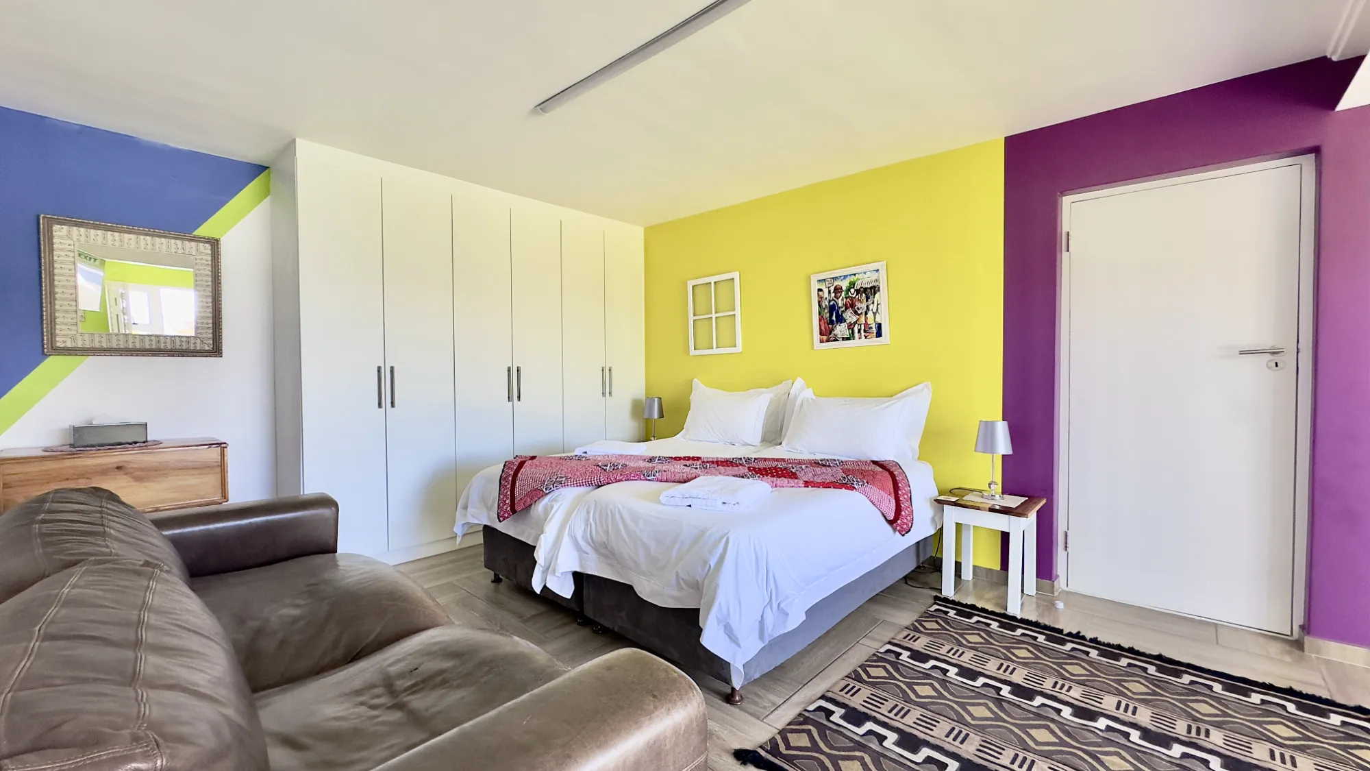 Wide view towards the bed of our District 6 room.