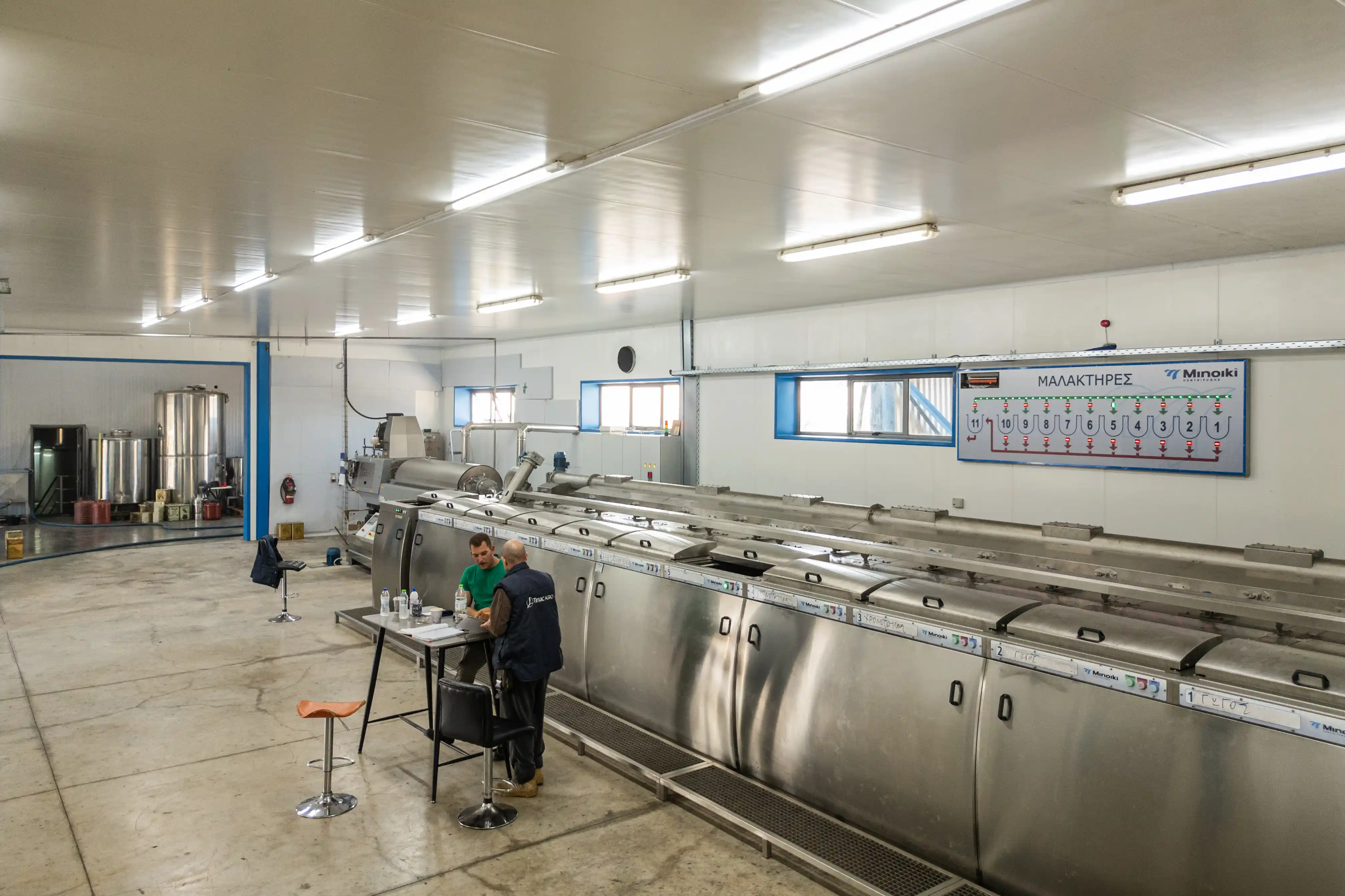 Interior of Fountas olive oil mill in Filiatra, Messenia, featuring state-of-the-art malaxers for premium extra virgin olive oil production.