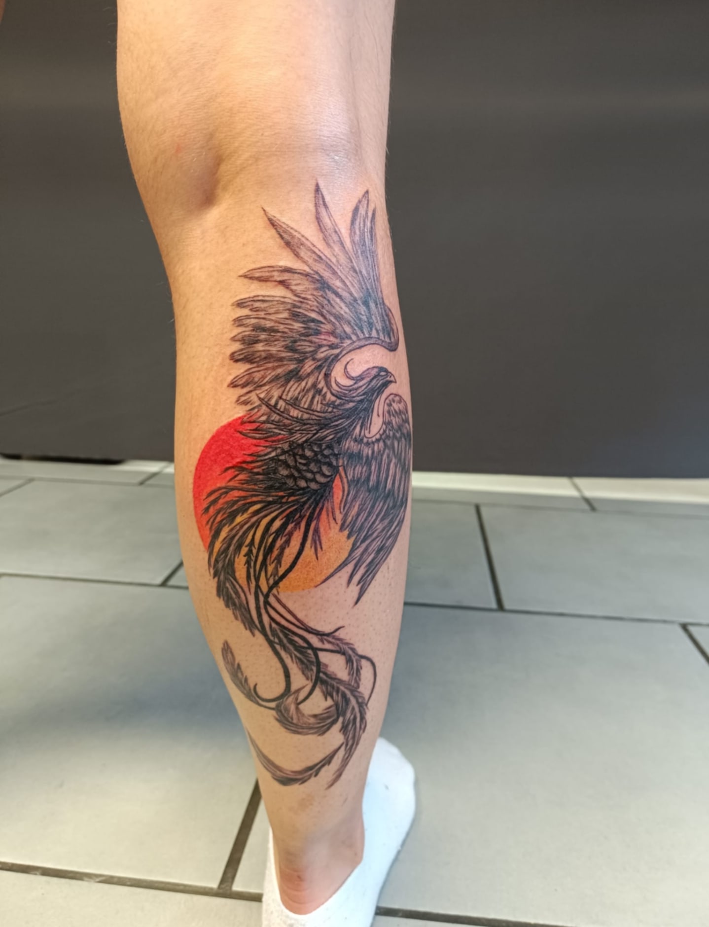 tatouage mollet homme oiseau rouge