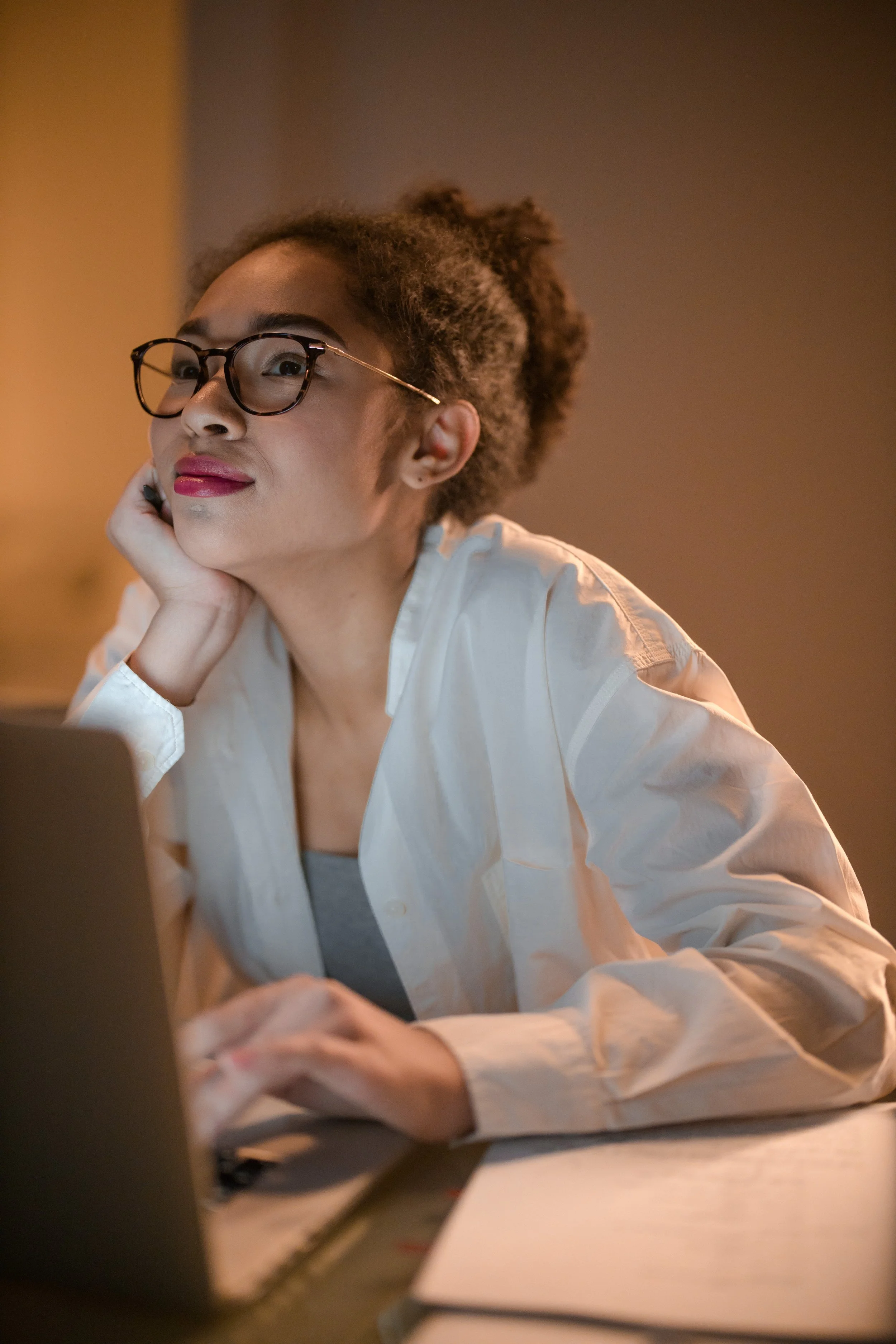 Woman pondering while at her computer