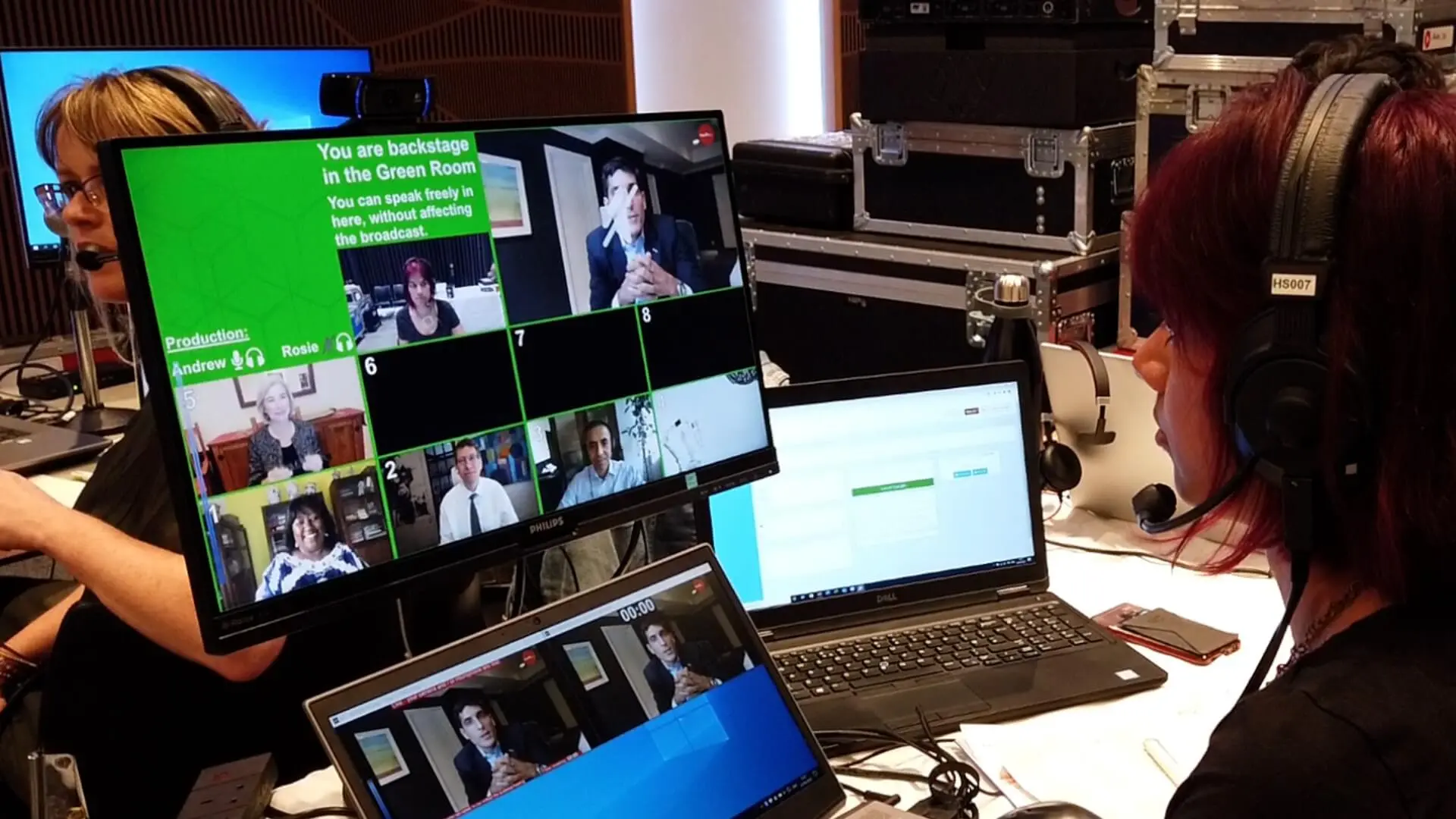 Live virtual event control room with producers monitoring multiple remote speakers on video call screens.
