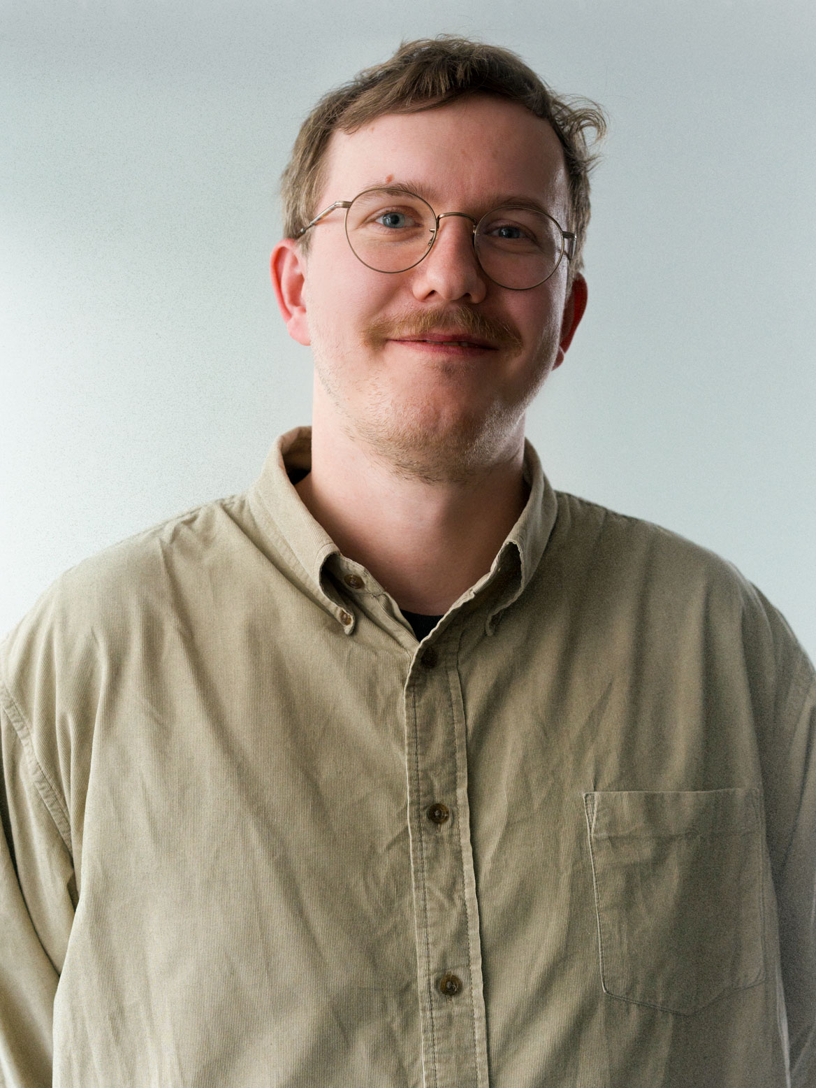 man standing beside wall