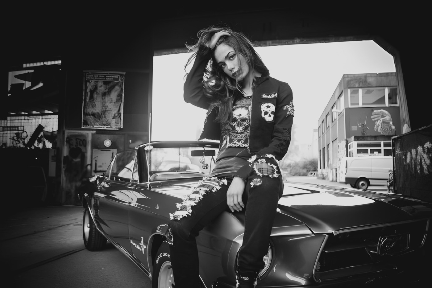 a woman wearing sunglasses laying on a bed