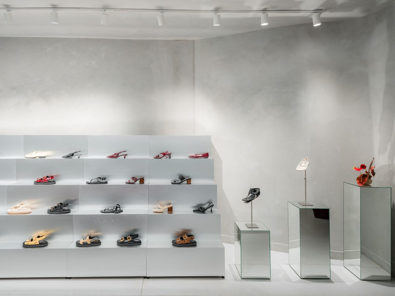 Gallery-like interior of the Alohas New York retail store with minimalist shelving and sculptural product displays.