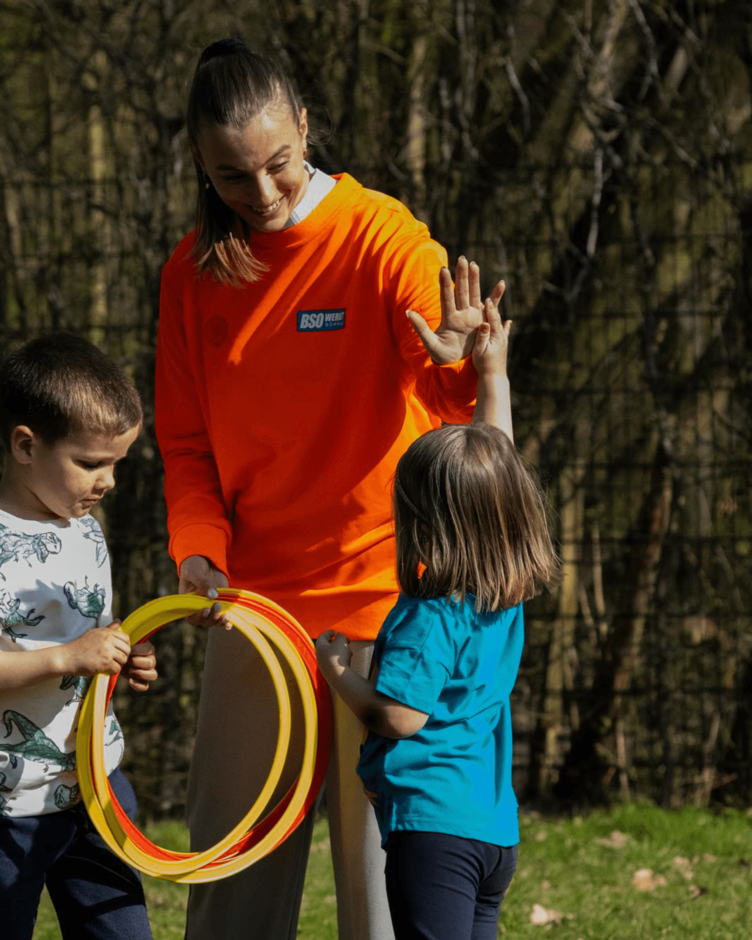 A rustic table set with various traditional pastries and a small bottle, surrounded by green foliage.