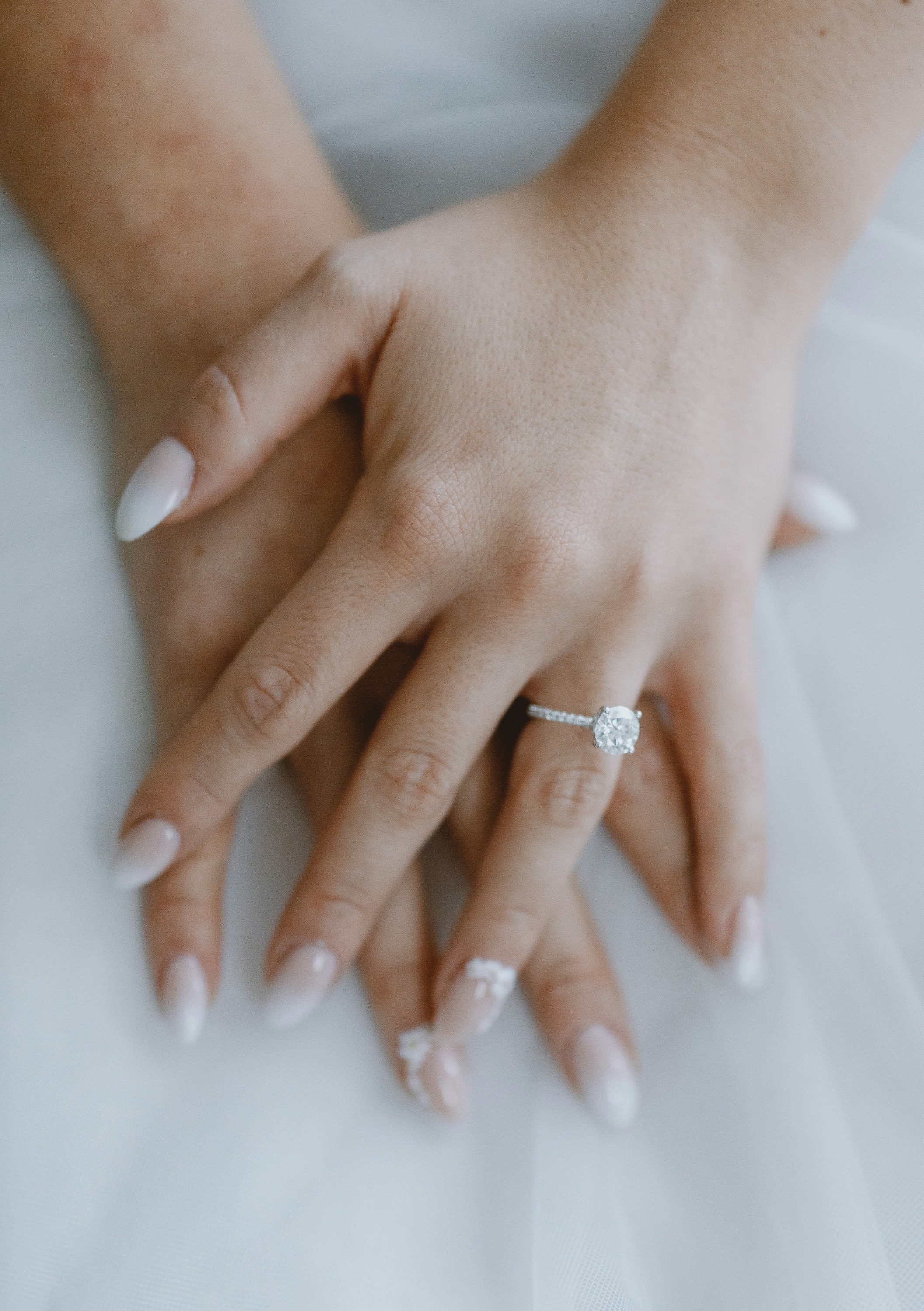 A close up of a woman holding her hand to her face