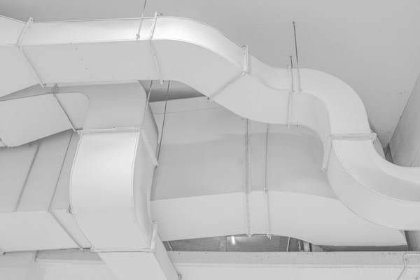 Clean round supply ducts running along a ceiling, delivering even airflow to each room