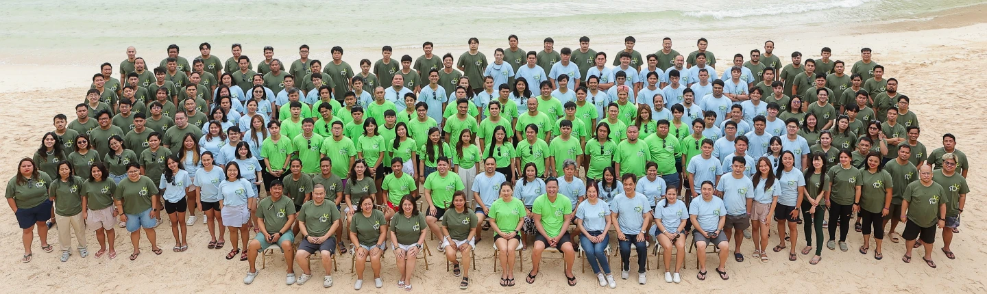A photo of a large group at the beach.