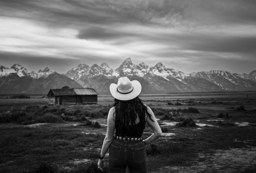An orange arch rock formation with sunlight peeking through