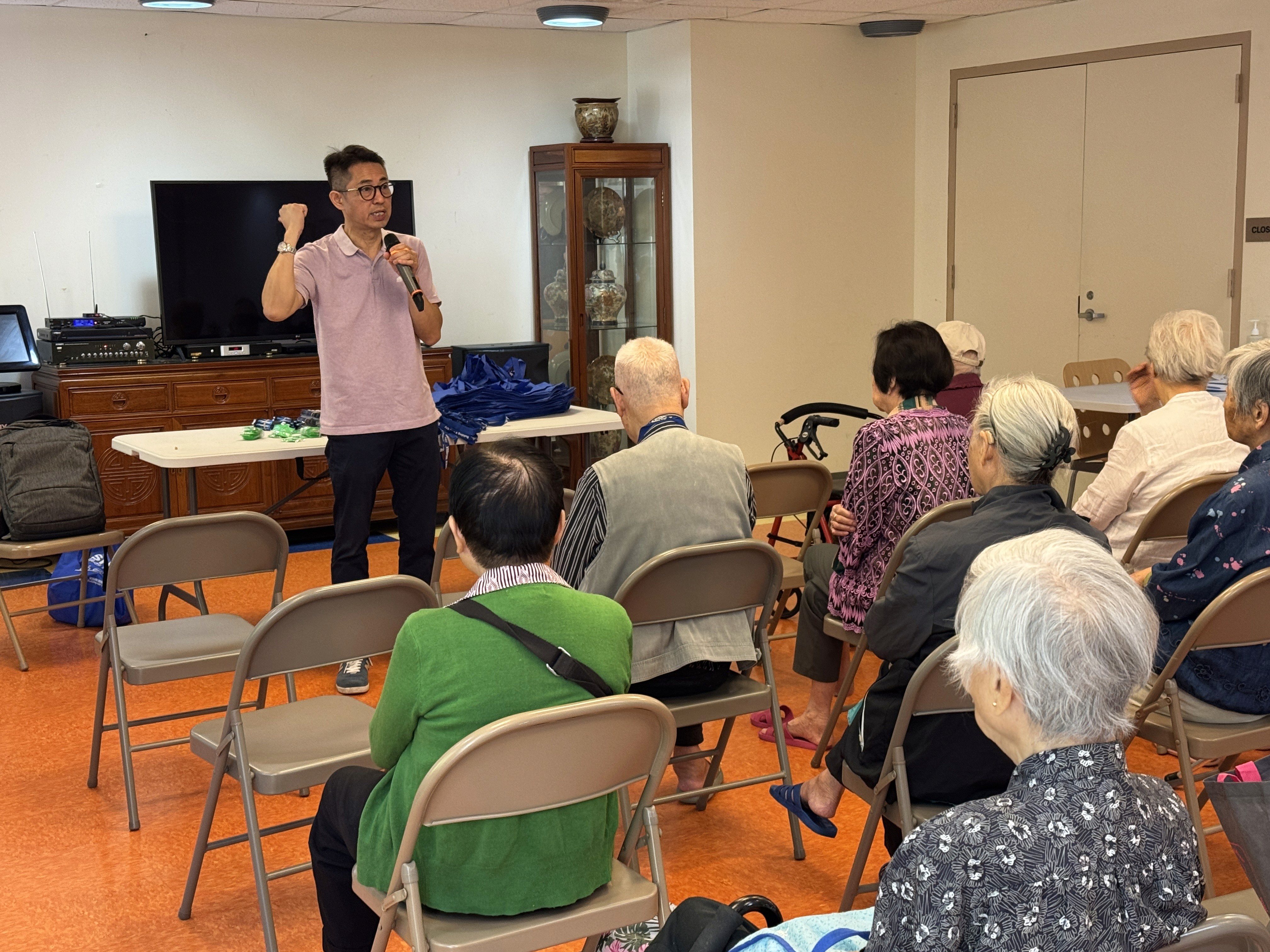 Instructor speaks to a group of older adults on safety guidelines.