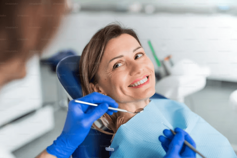 Dentist smiling with patient while preparing for a dental filling