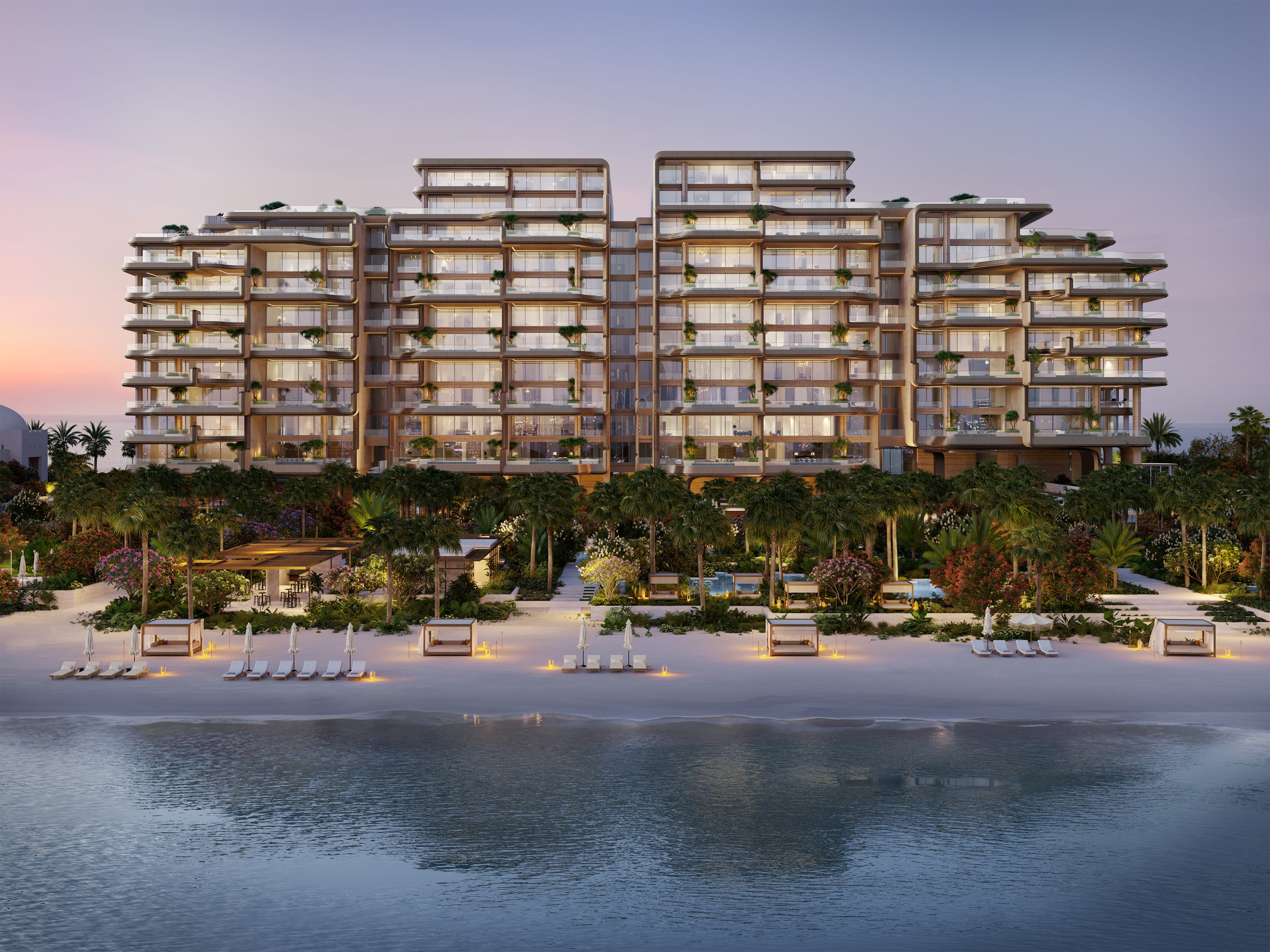 Vibrant sunset over "Enara by Omniyat," a beachfront apartment complex, highlighting its modern architecture and serene setting.