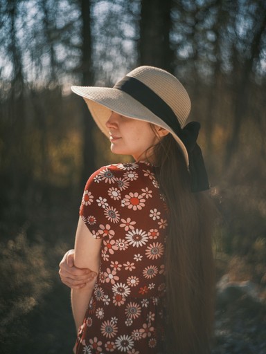 side profile portrait of a young woman with swirly background blur