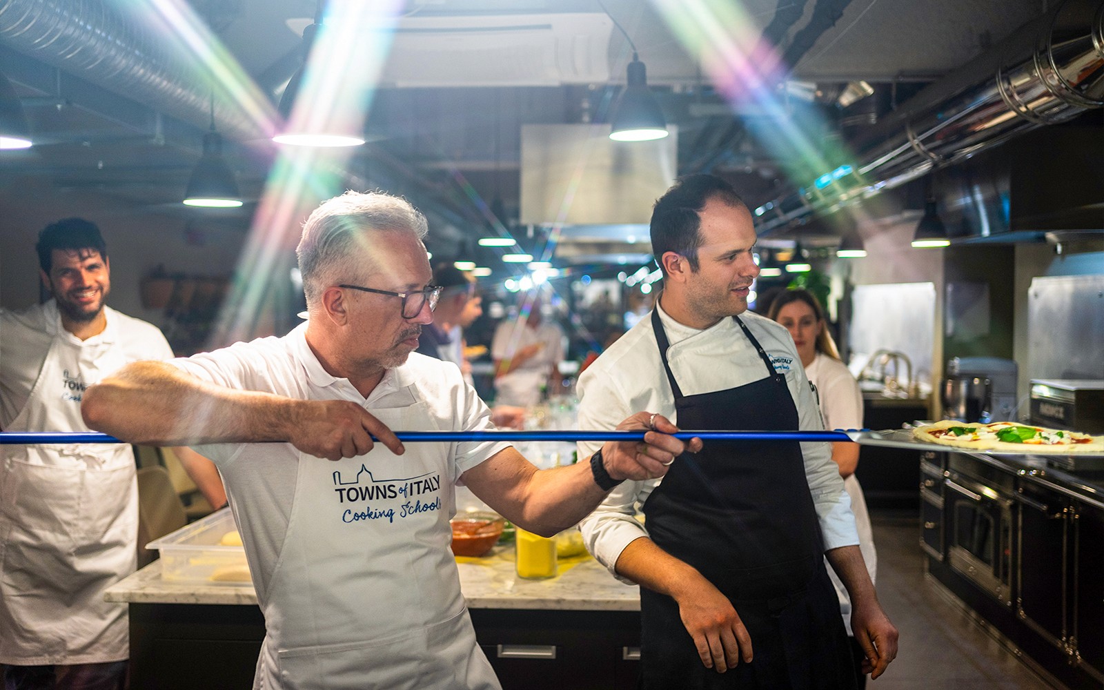 Participants learning to make pizza in a cooking class in Milan.