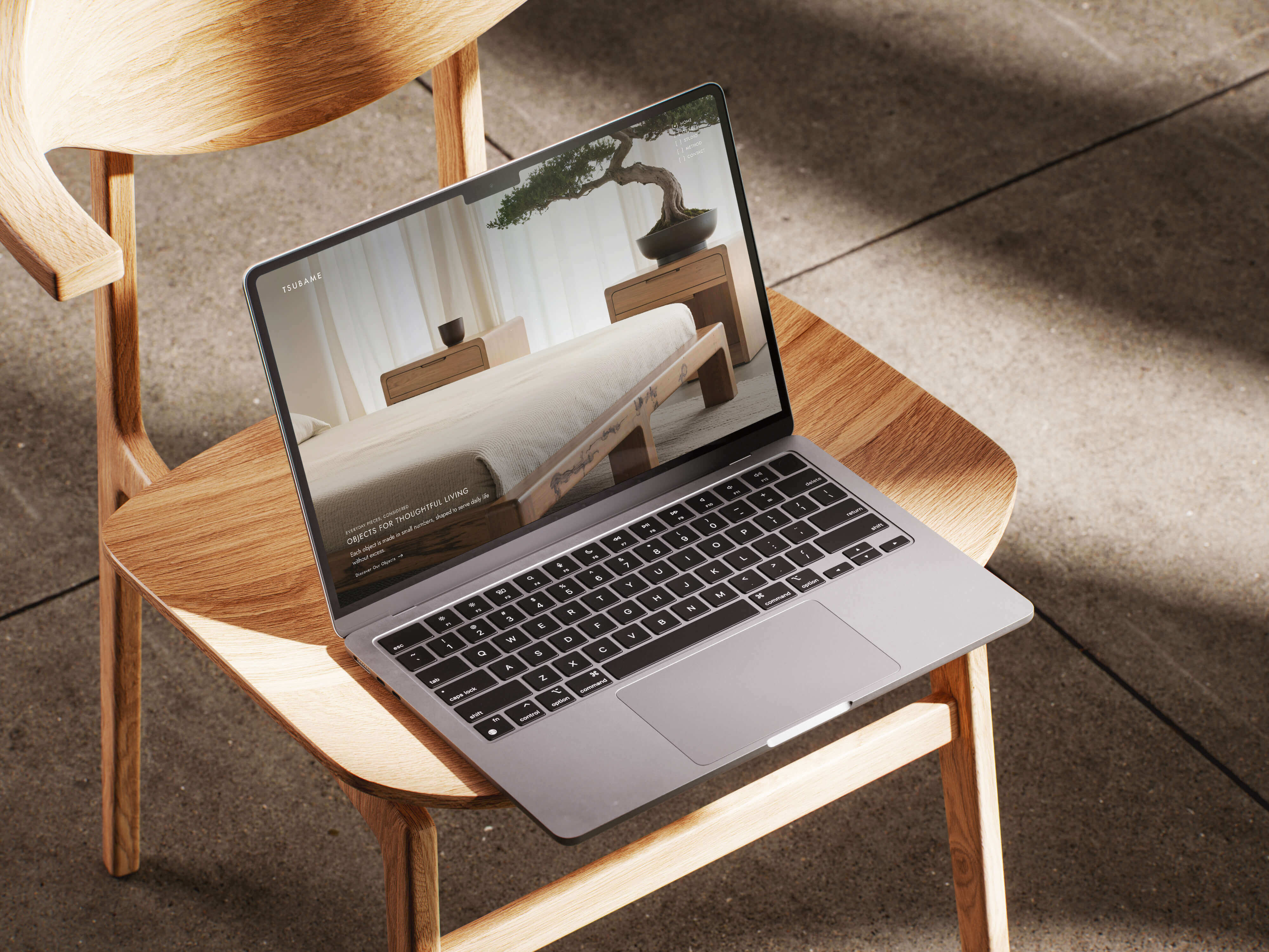 Tsubame website hero displayed on a macbook in a high-end interior setting