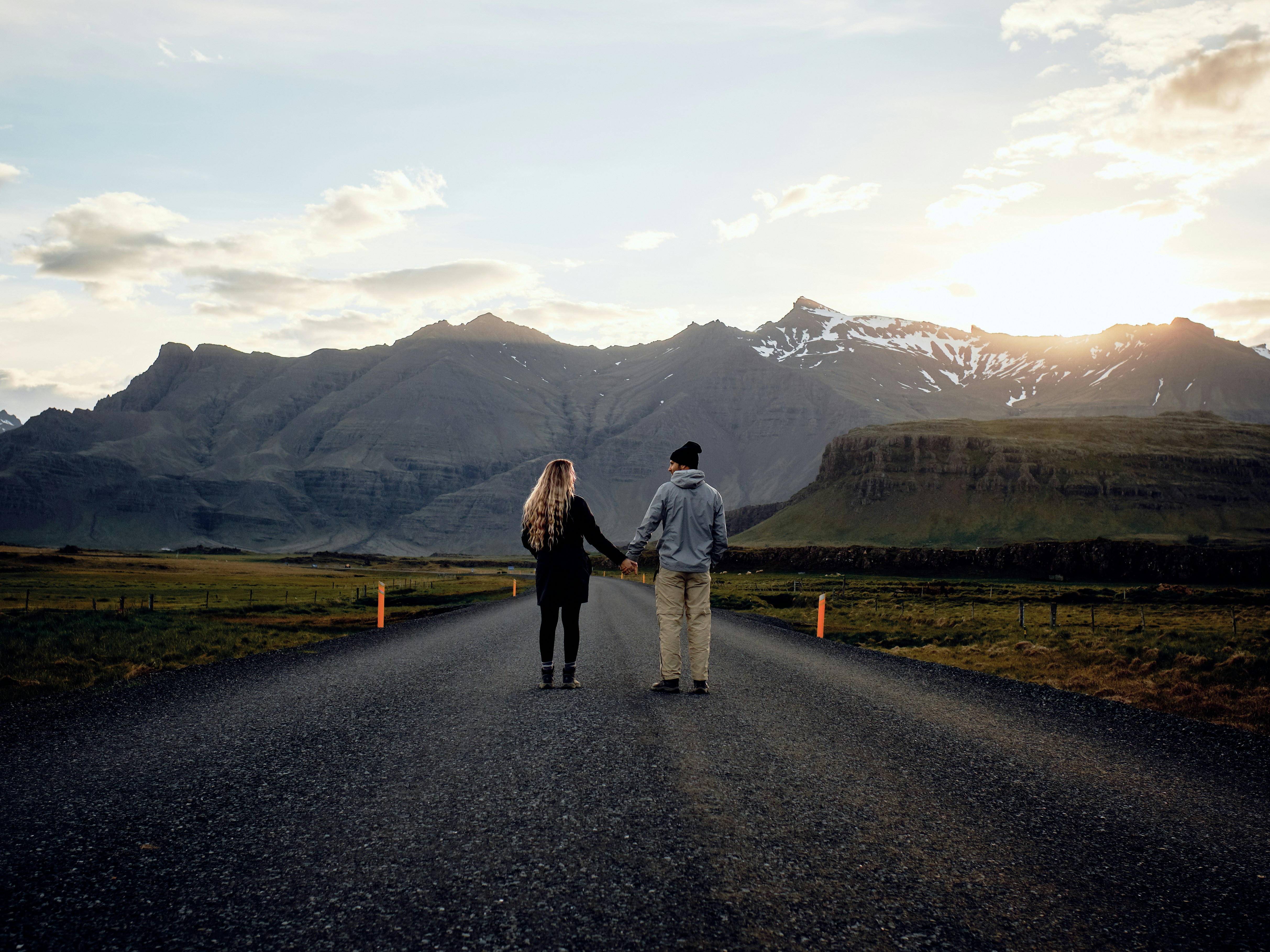 Couple holding hands along Iceland’s Ring Road.