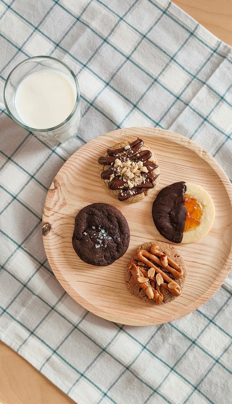 Tray of assorted artisan cookies served with a glass of milk
