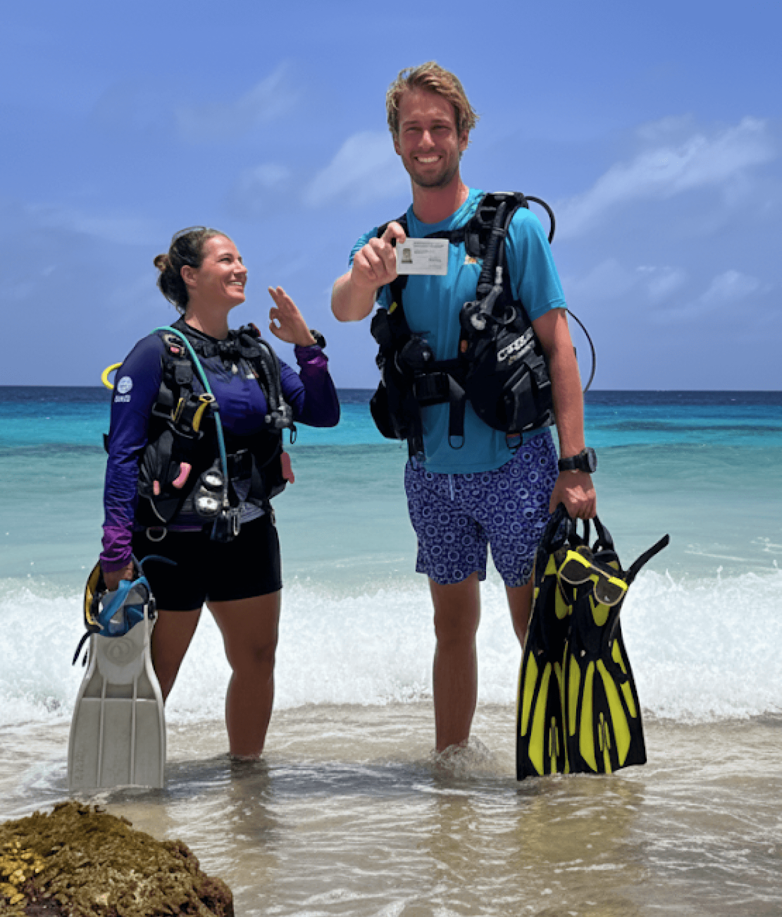 Team Showing Dive Tankcards in Bonaire Beach