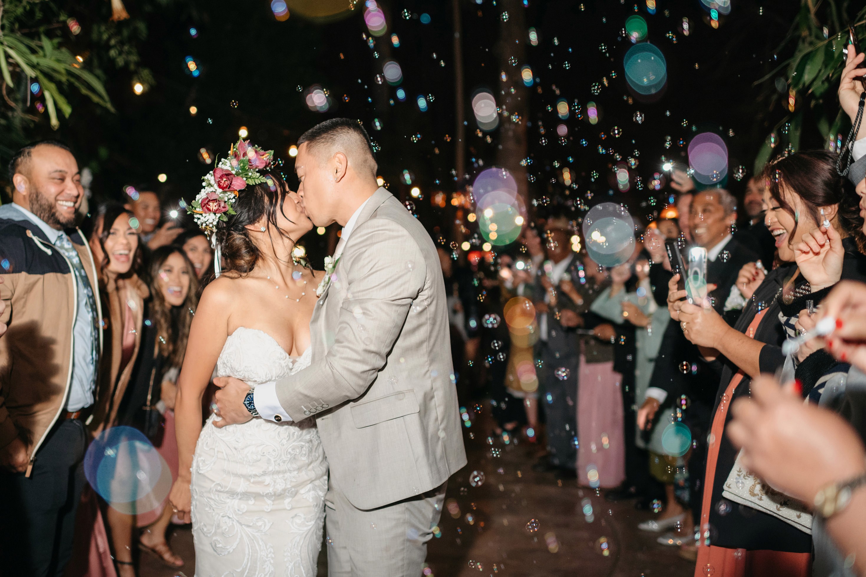 Night portrait of bride and groom grand exit with bubbles in the background