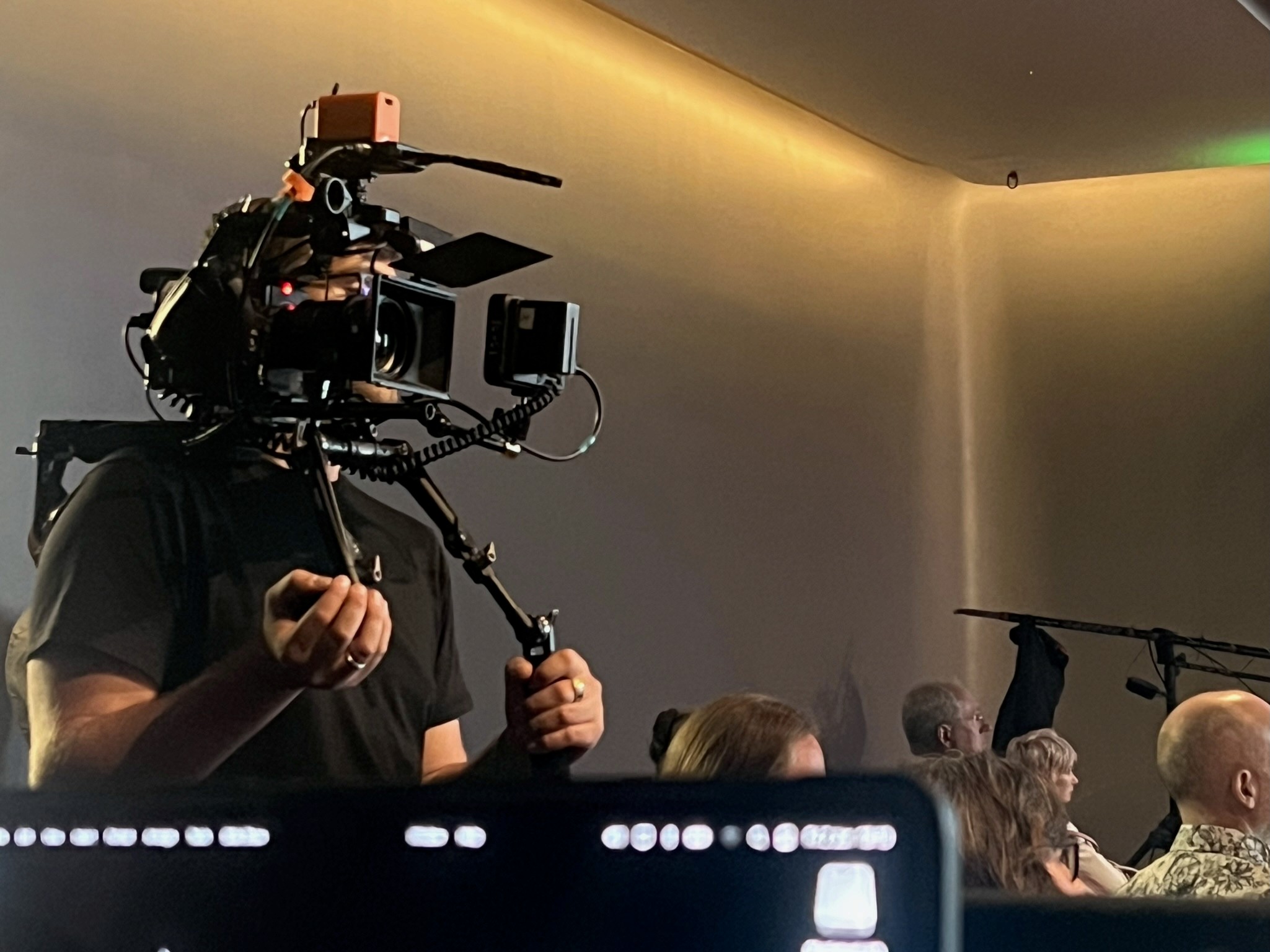 Stage Engage camera operator filming a live event with a shoulder-mounted broadcast camera