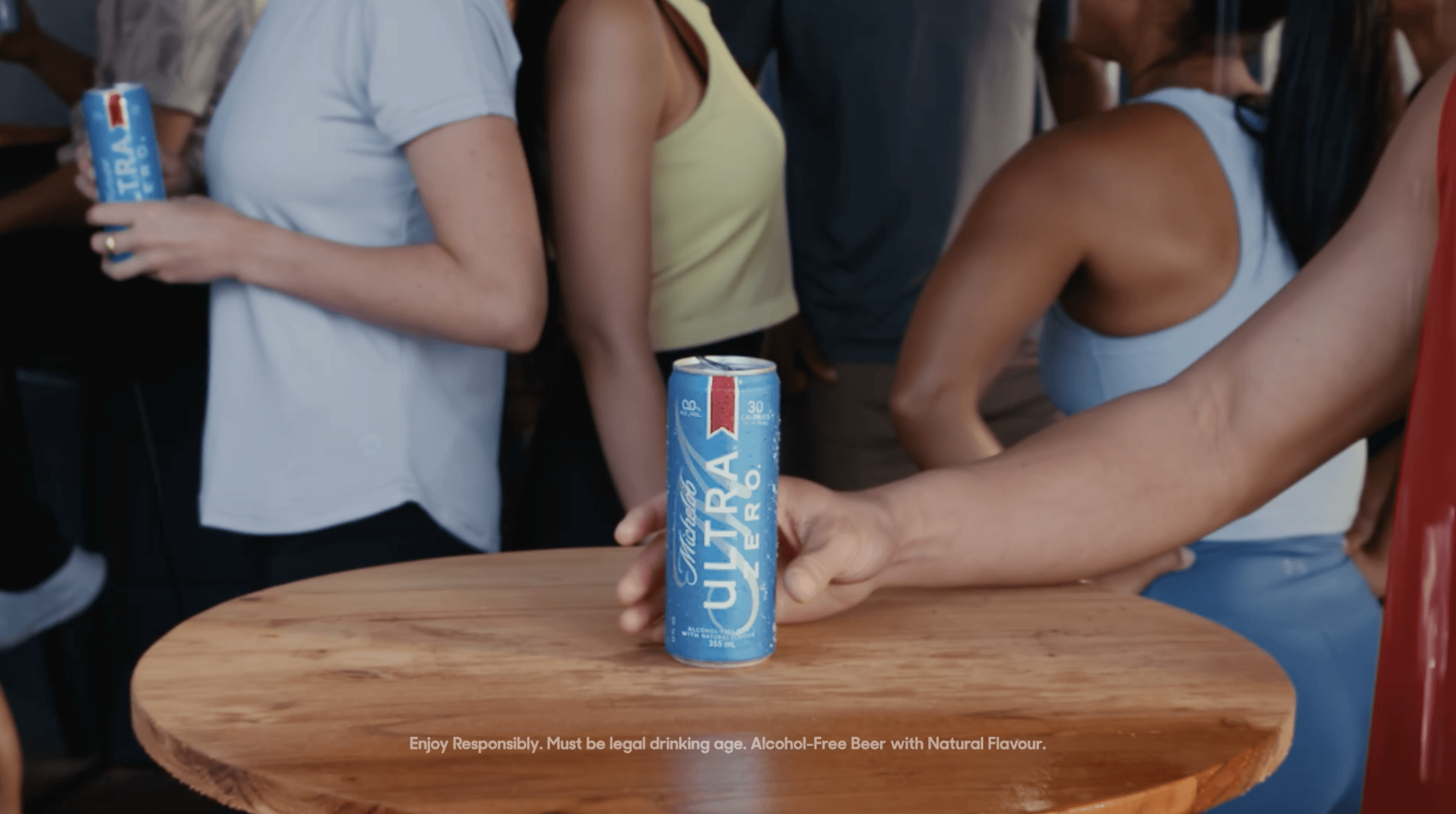 A close-up of a hand wearing multiple decorative rings against a blue background.