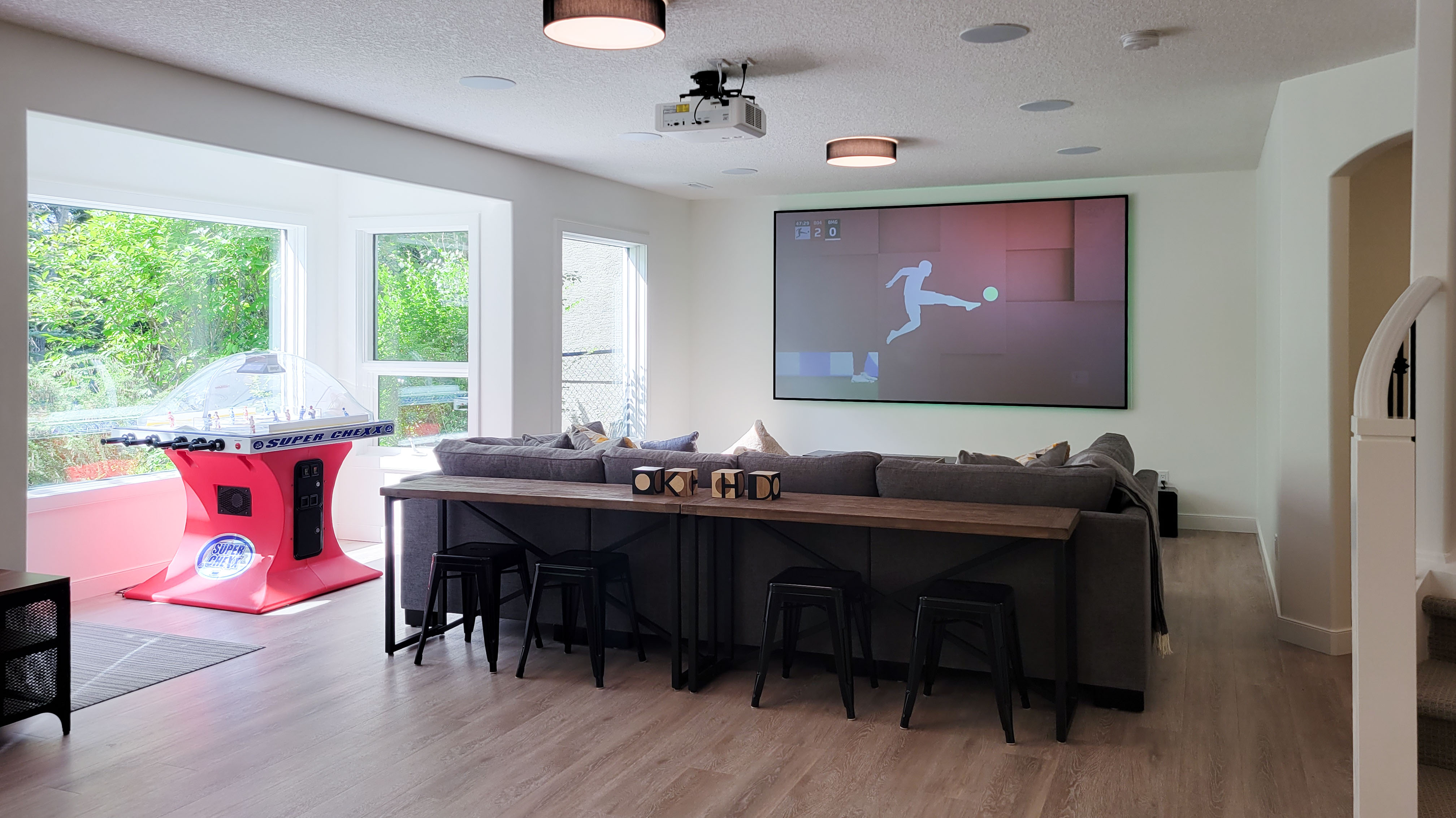 Image of KHD Homes game room with layout design, furniture, and large screen for home improvement and design.