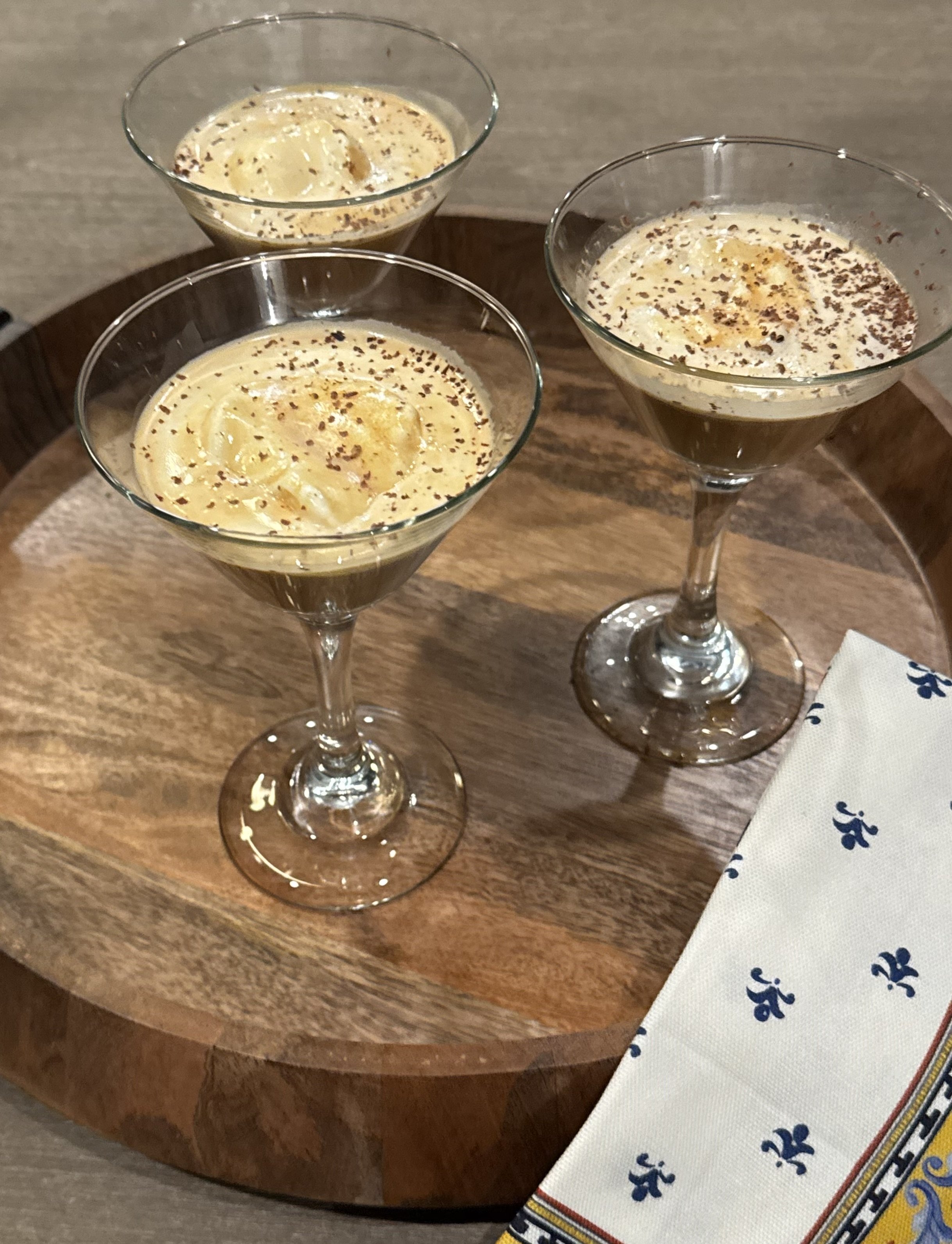 Three glasses of ice cream and coffee topped with chocolate shavings