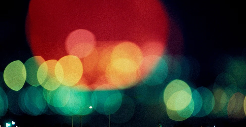 Artistic portrait with red and blue lighting creating a dramatic effect