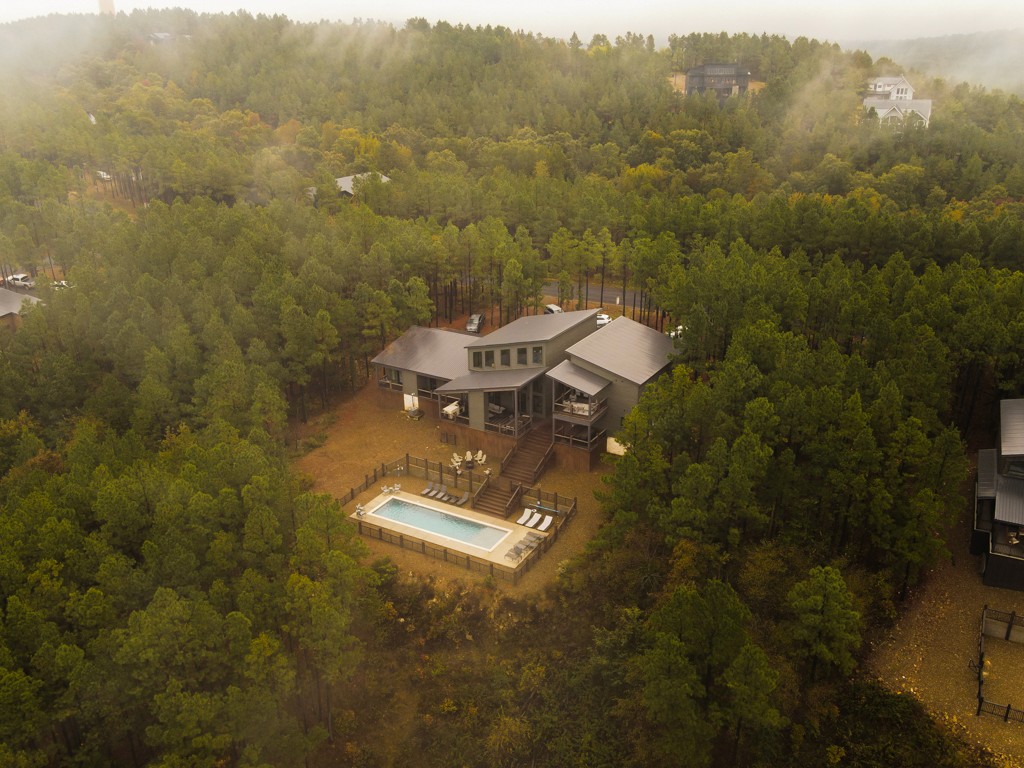 Drone aerial of cabin in woods