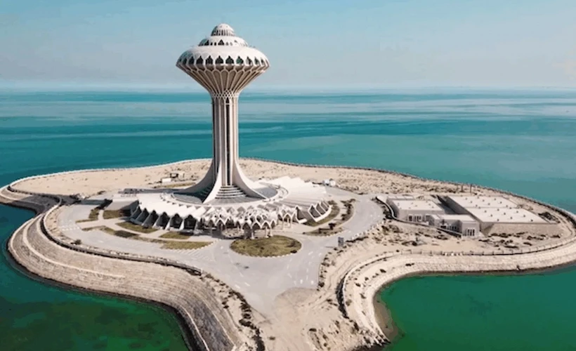 green chairs under umbrellas on shore