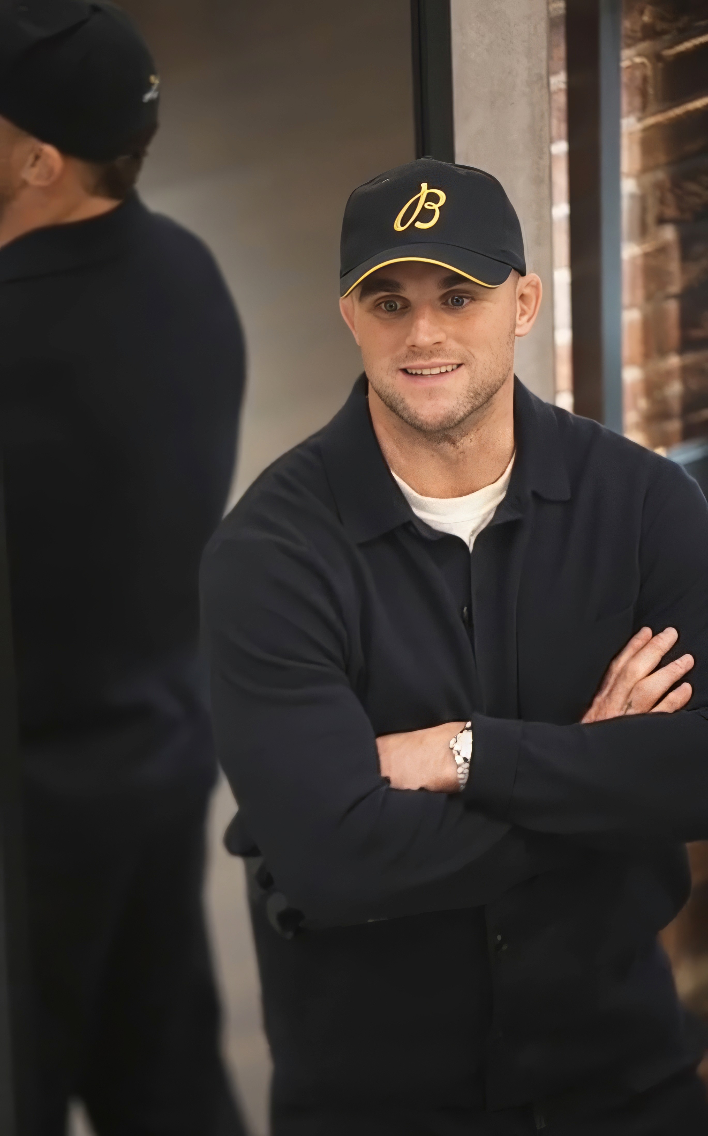 Bride in white dress walking on street, man in background